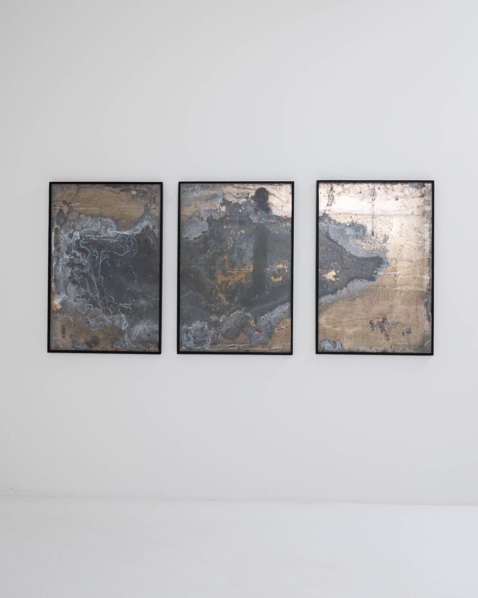 Bold and enigmatic, this large-scale abstract triptych combines the hand of man and the hand of nature. The form has a minimalist simplicity: three sheets of metal are set within black wooden frames. The surface of the metal combines human