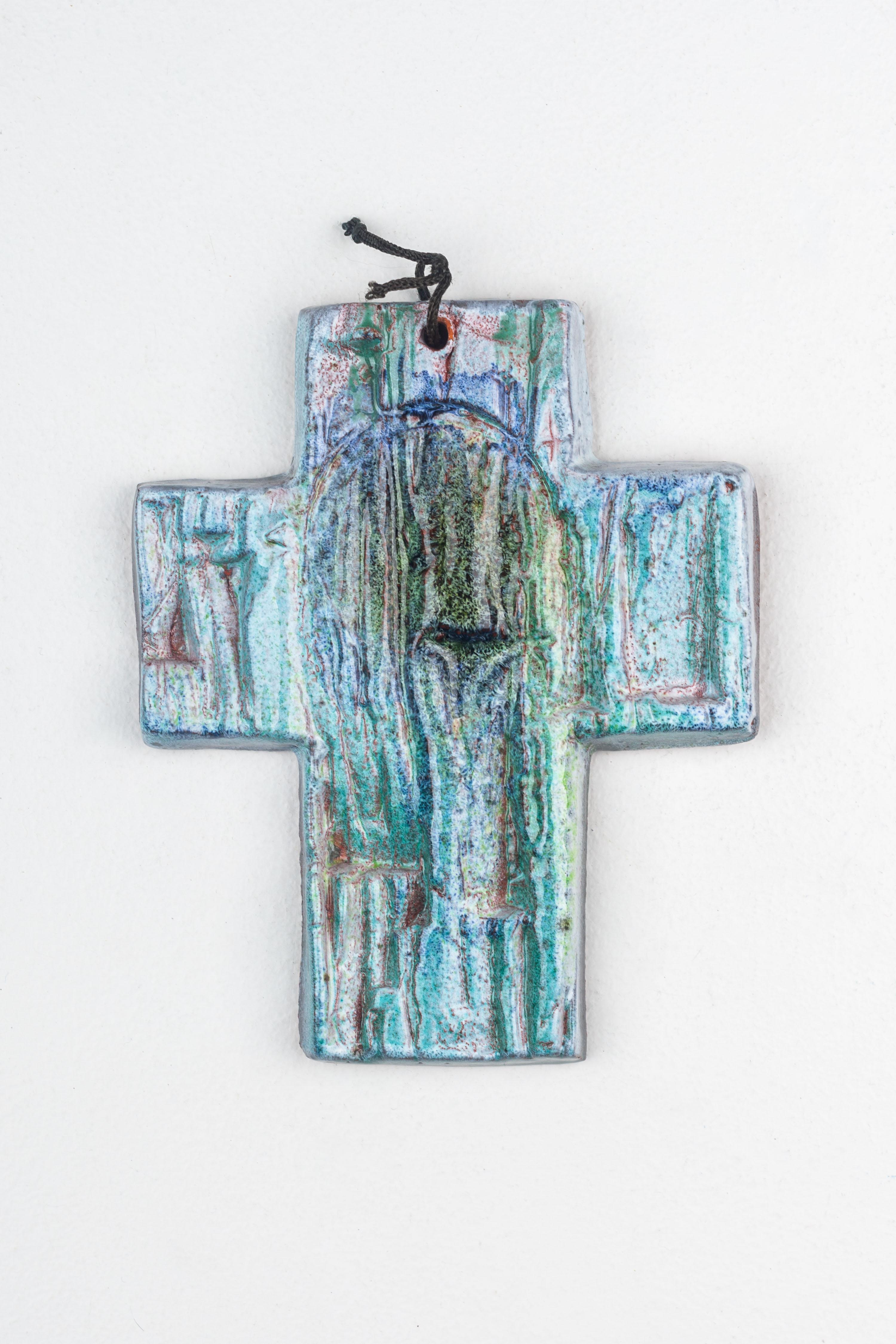 This mid-century modern ceramic cross is an exemplary piece of European studio pottery that displays the innovative and abstract artistry of the period. The piece is characterized by its textured glaze, which creates an almost ethereal landscape