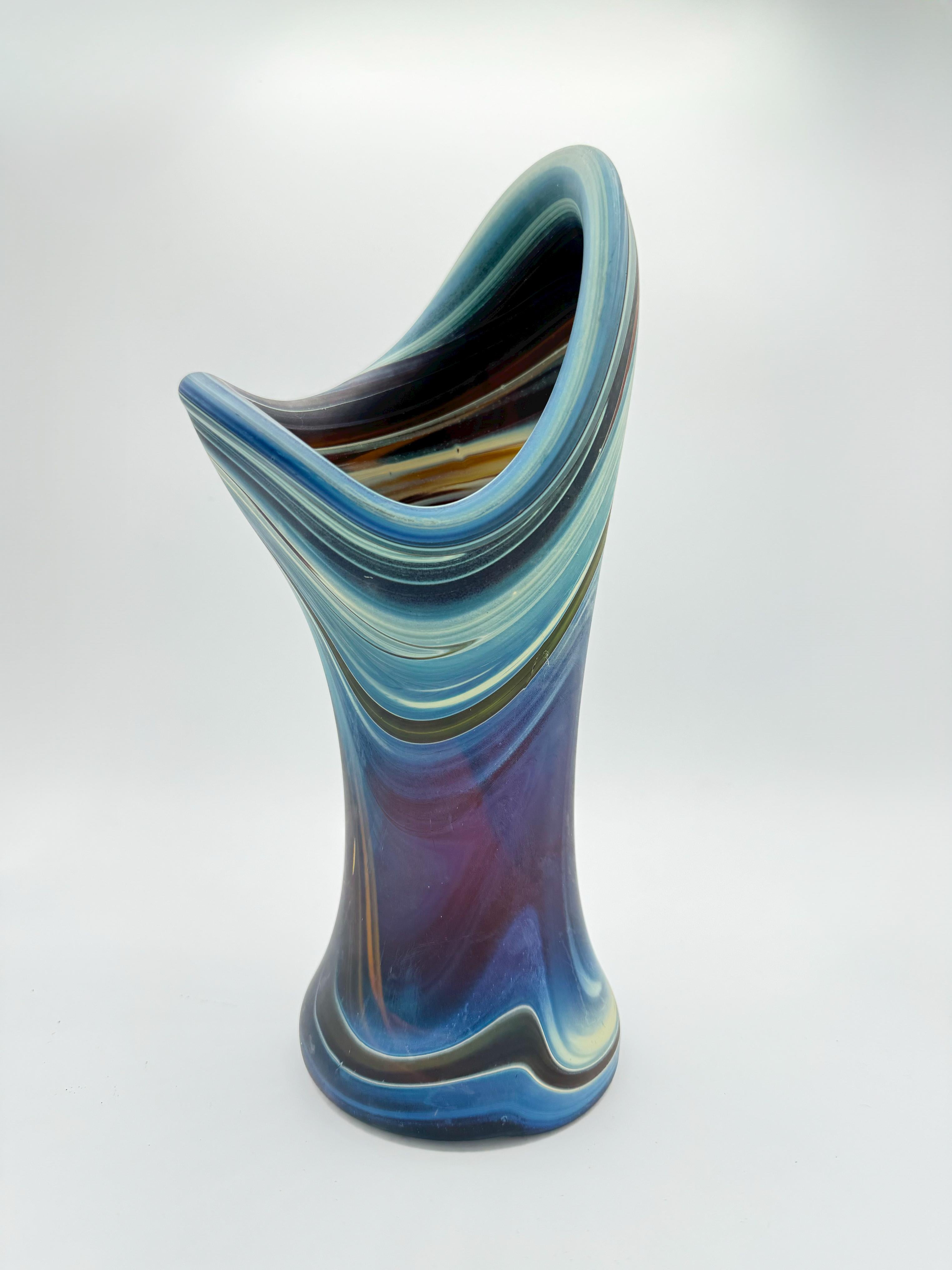 This beautiful vase, crafted in the style of Hebron glass, is a unique find. Hand-blown with exceptional skill, it features vibrant colors and intricate patterns typical of Hebron glasswork. The vase is heavy and in perfect condition, with no chips