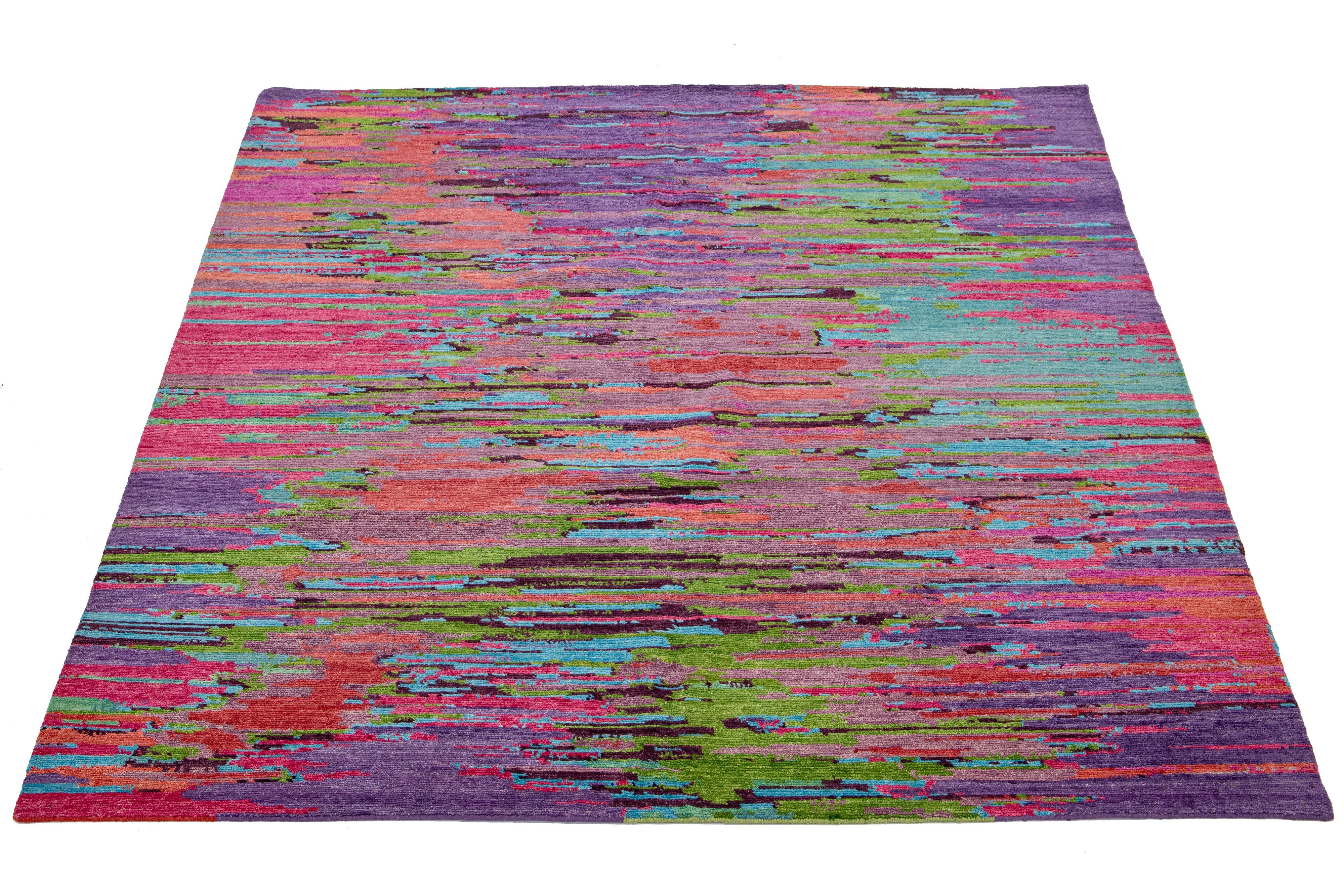 This beautiful, modern-textured hand-knotted wool rug features a multicolor color field of purple, pink, green, and blue. The rug also boasts a stunning textured abstract design.

This rug measures 8' x 10'.

Our rugs are professionally cleaned