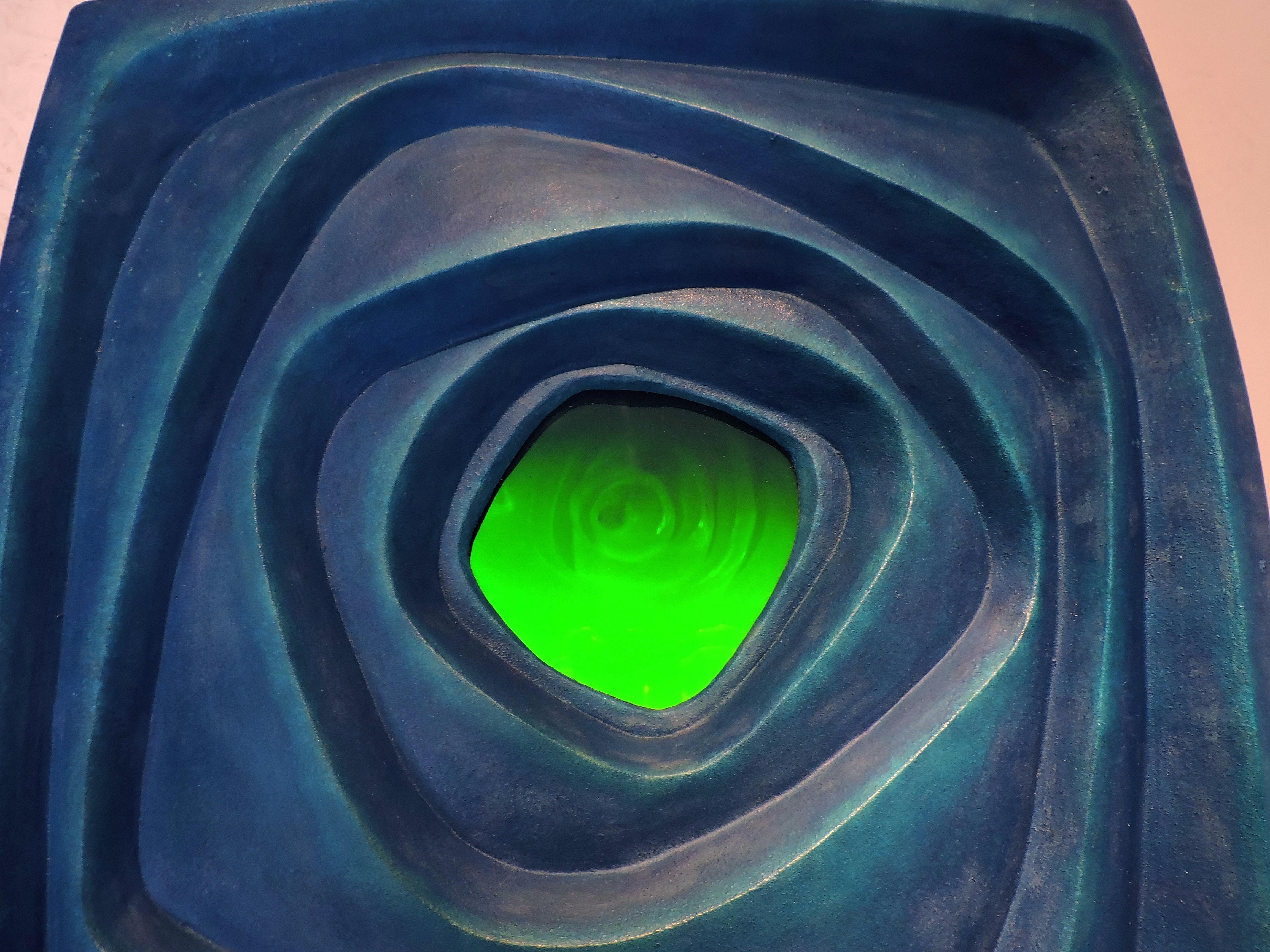 INTERIOR SPACES 2 is one of two abstract wall sculptures made of anodized aluminum combined with holography. This sculpture was sand cast in aluminum, then anodized in shades of blue, and has an inset glowing holographic image.

About this
