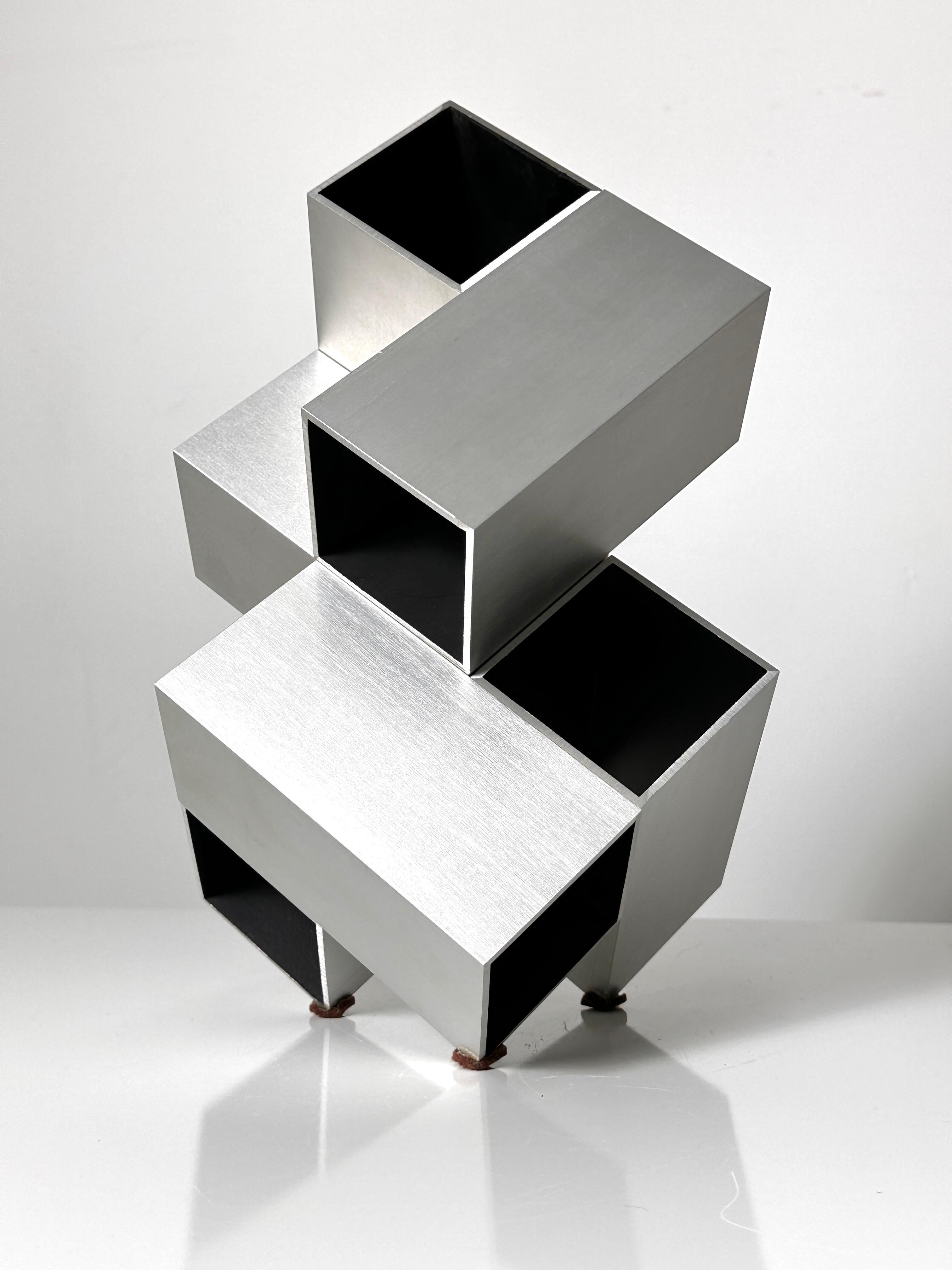 Modular Cube sculpture by Israeli artist Kosso Eloul 1920-1995

Two pieces in brushed aluminum with black painted wood interior
Purchased in Toronto by the original owner circa 1970s  

Overall dimensions
9.5 inch width
9.5 inch depth
14.5 inch