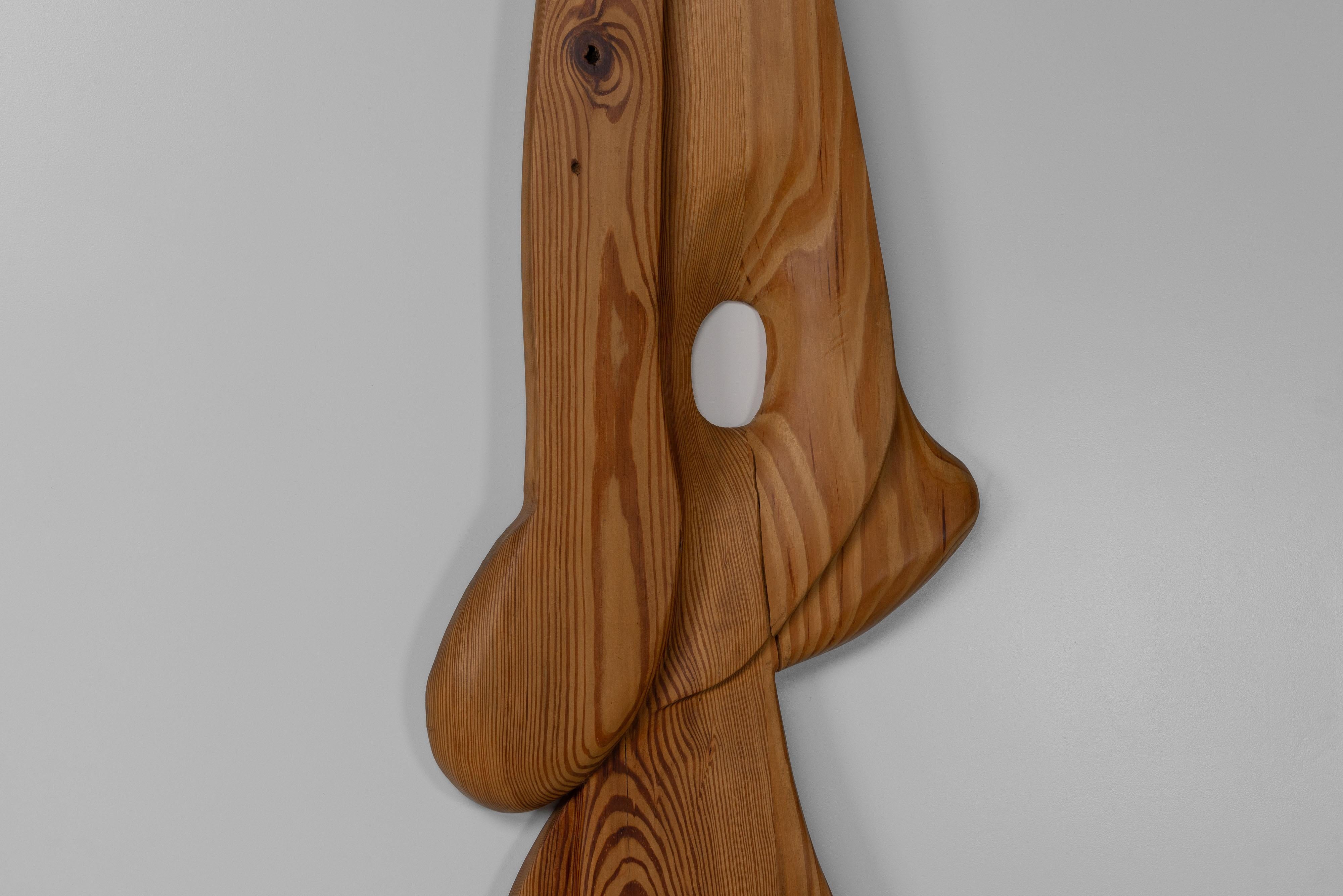 Beautiful organic shaped wall sculpture made by unknown artist in France, 1973. The stamp on the bottom says Romoh 73. The solid pine wood has a nice pattern This sculpture has a unique shape that might remind you of a figure, but feel free to let