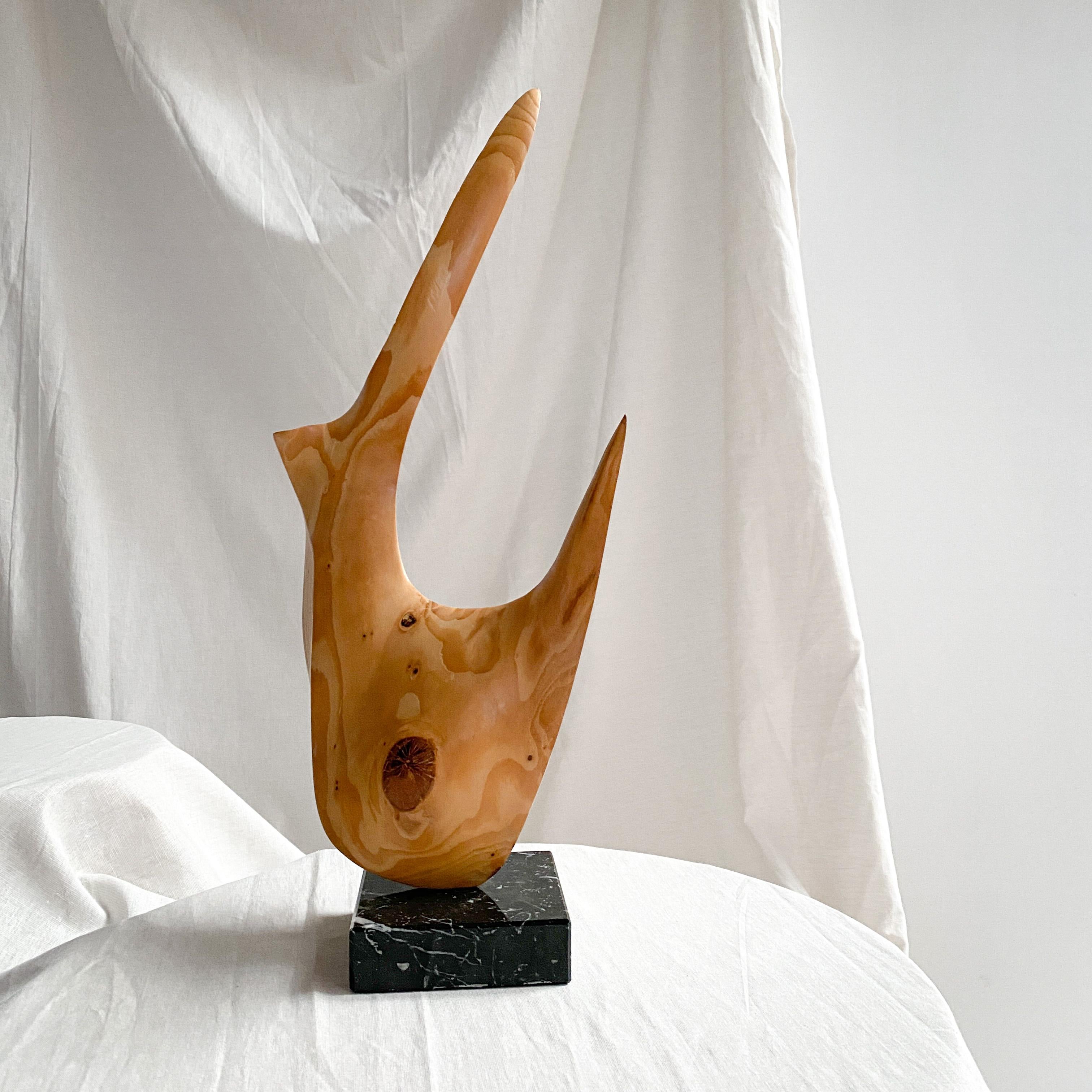 An intruding wooden sculpture in an abstract shape. A playful interpretation of an open & closed volume. Although not huge in size, the sculpture as a strong spatial presence. Handcarved out of wood, placed on a marble base. Highly decorative