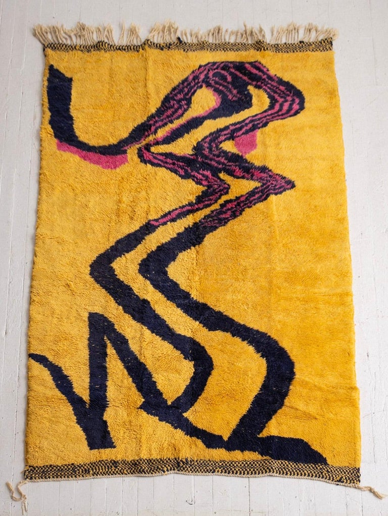 Hand knotted Moroccan wool rug. High pile shag. Graphic abstract pattern reminiscent of the 1960s. Vibrant yellow, pink and navy blue.
