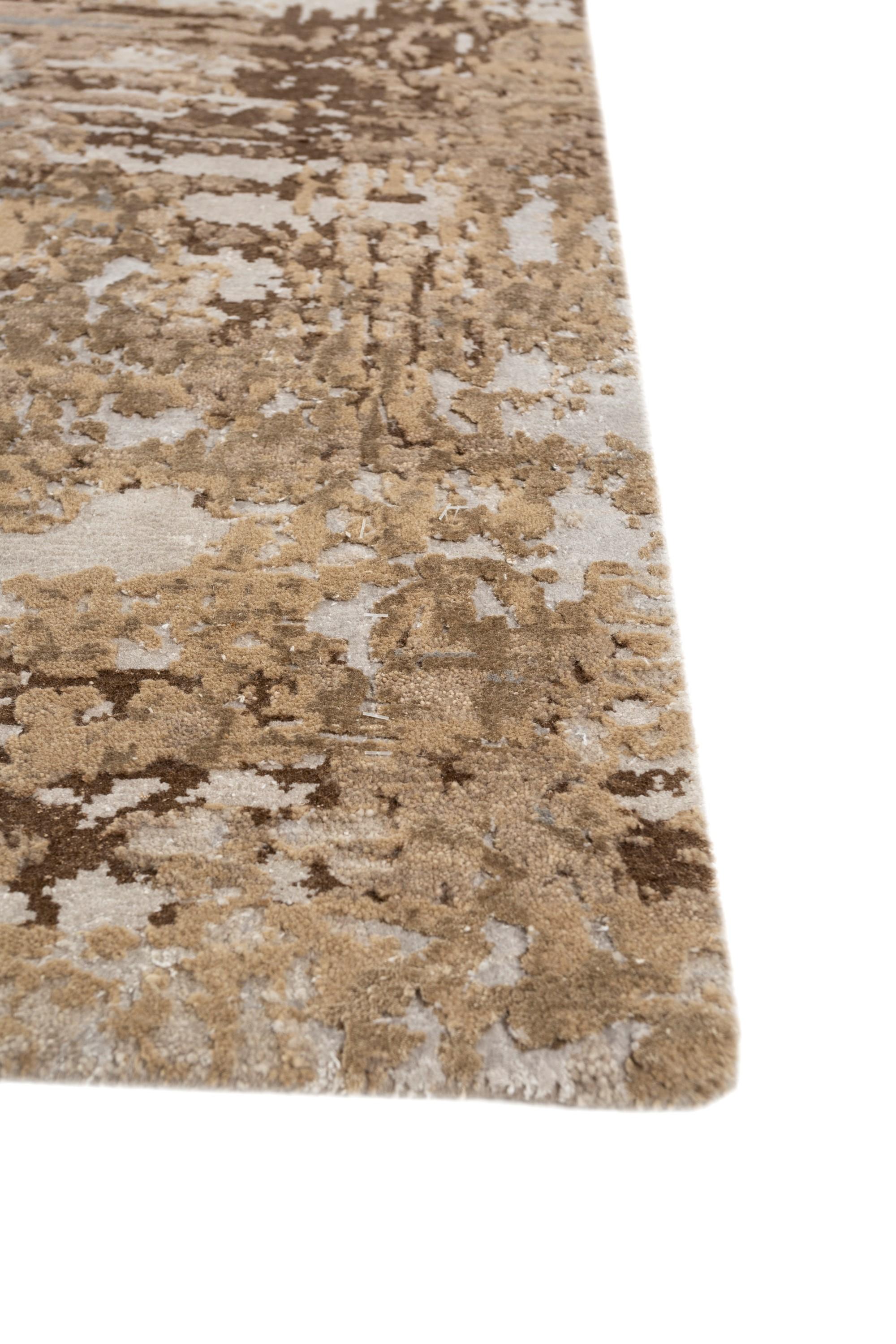 Introducing this hand-knotted rug in mink and classic gray colors with a modern design that finds beauty in errors. Inspired by nature's interruption of mechanical duplication, this rug is a unique piece of art, showcasing spontaneous and