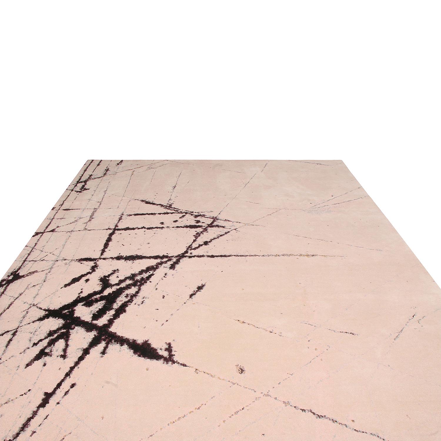 Hand knotted in one of the most reputed workshops in Nepal, this modern wool and silk rug enjoys a brilliant, very modern use of contrast, marrying the striking abstract field design with both bold and soft, forgiving hues. The remarkably subtle