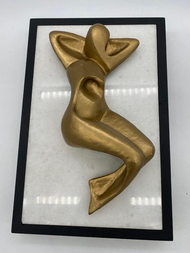 Unsigned bronze abstract nude fixed to a white marble base mounted to a black frame on a lazy Susan turntable base that can be rotated 360 degrees. The sculpture is designed to be set on a table and viewed from above.  

Unsigned, 1990