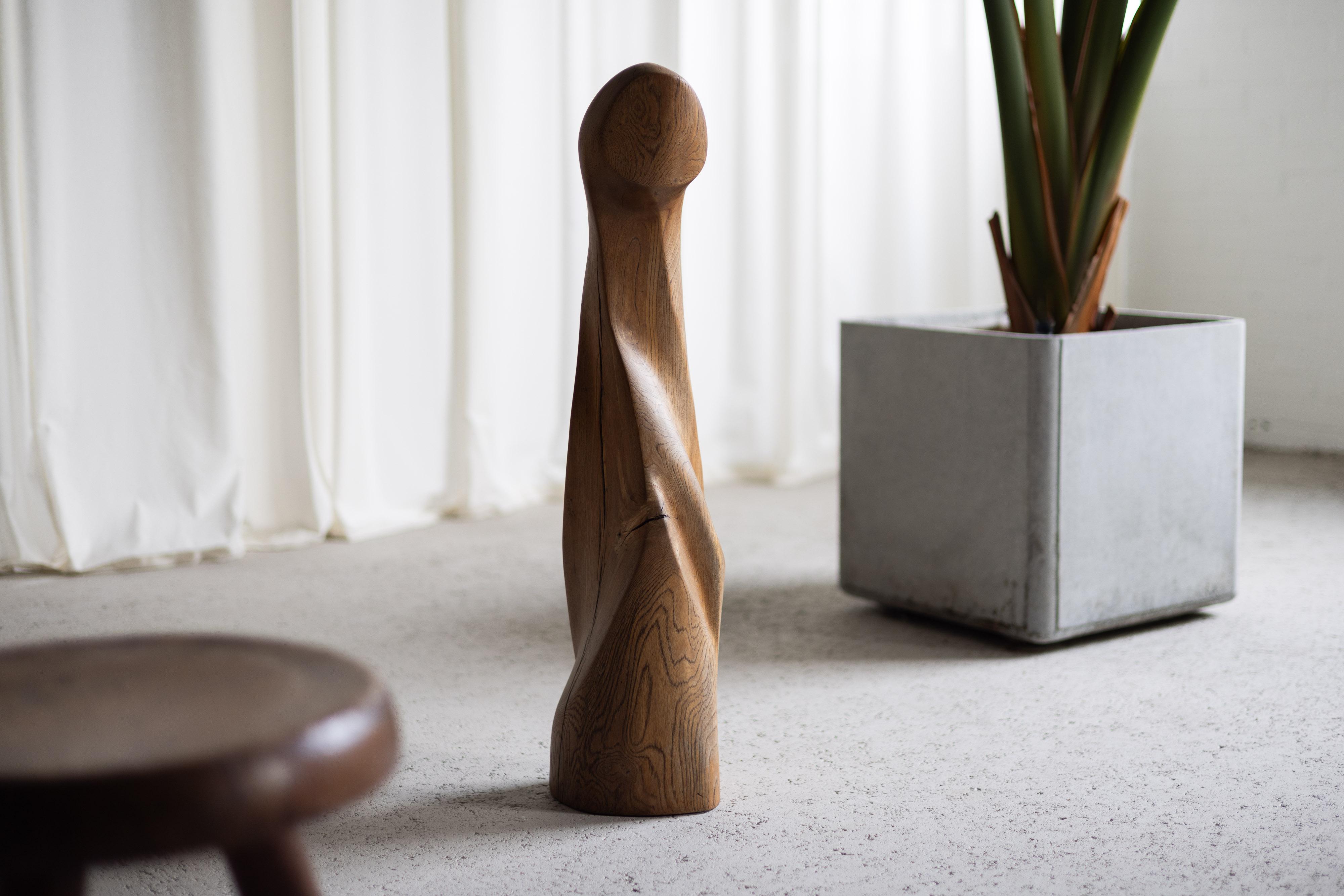 Beautiful shaped abstract modern scultpture made in France, 1960s. This sculpture is made from solid oak wood showing its beautiful grain and texture. Shaped like a figure, it has impressive fluid lines and forms that become even more accentuated