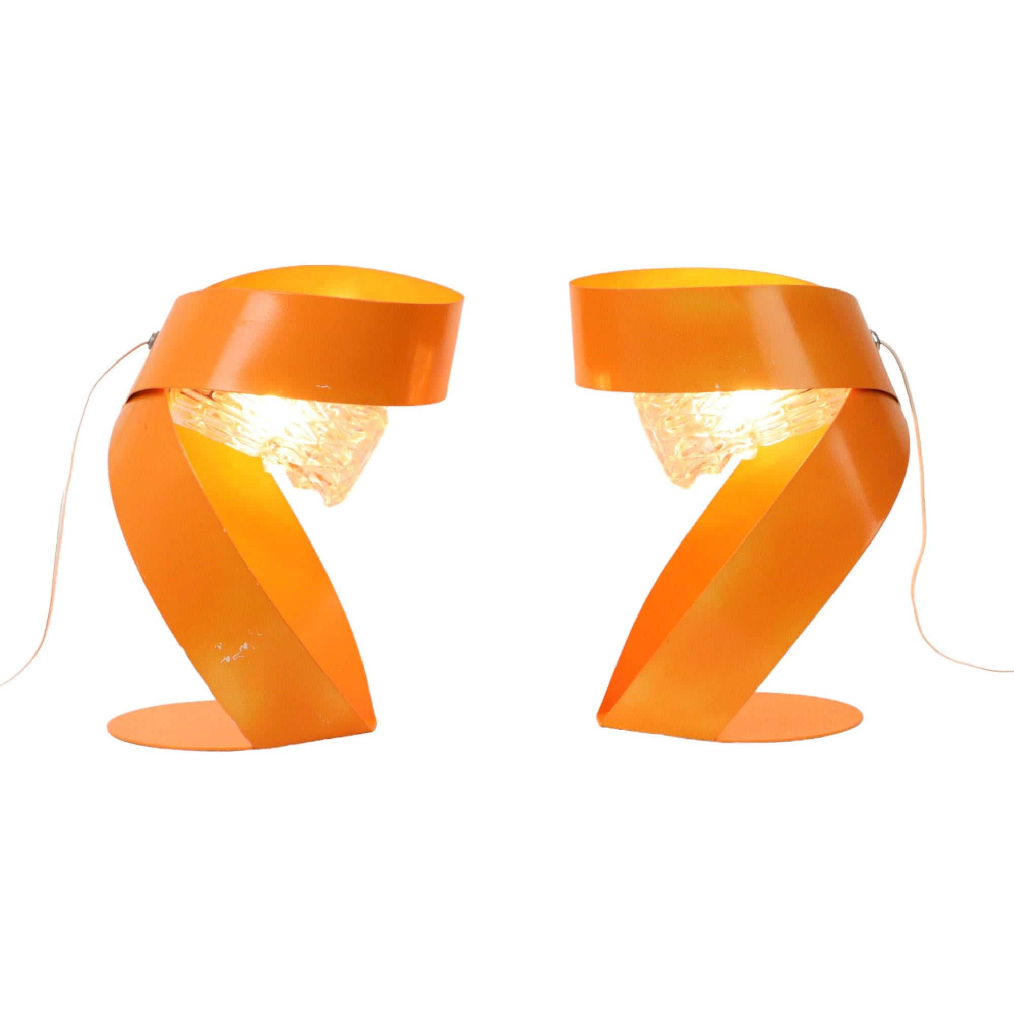 Set of 2 abstract orange table lamps completely in space age style, night lights with a sleek design, made of orange lacquered bent metal, 60s, France.

This set of lights is most likely a personal creation of a handy Harry, old copper fittings with