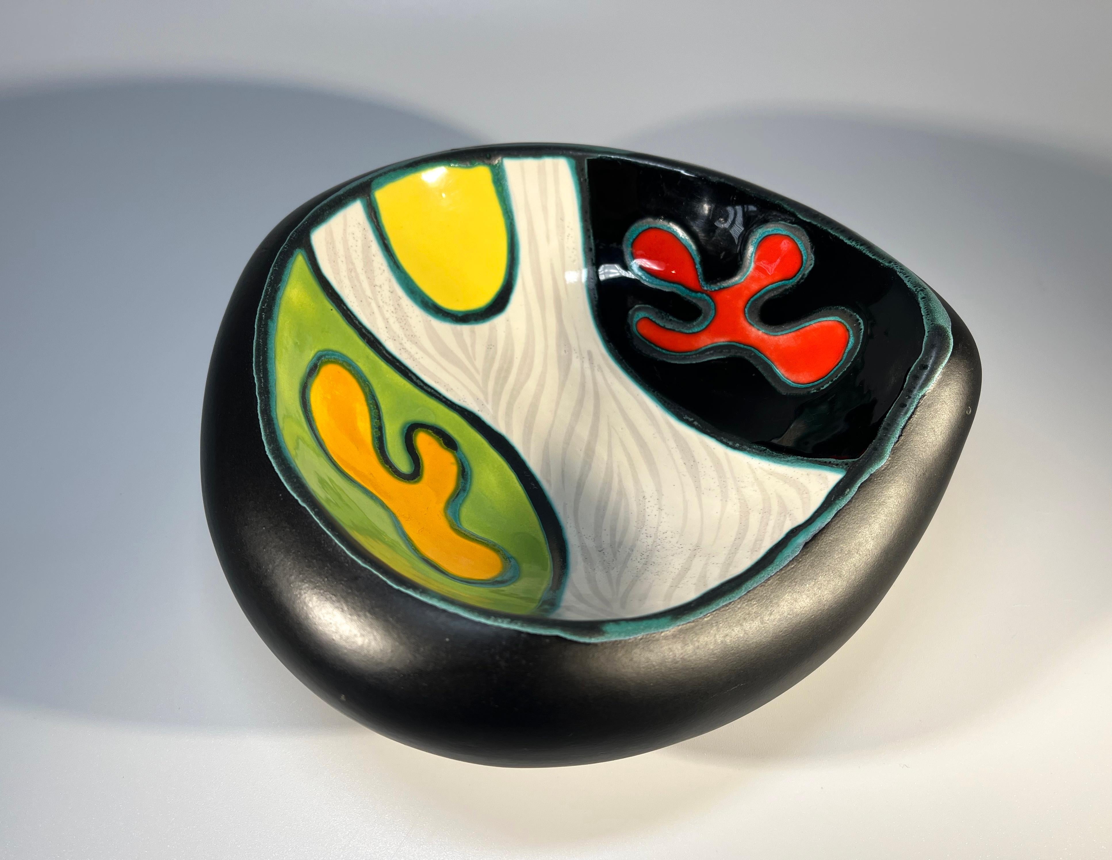 Organic in form, abstract ceramic vide poche by Gabriel Fourmaintraux, France
Strong pallet of red, yellow and orange enamels contrast wonderfully with the exterior matt black glaze
Circa 1950
Height 1.5 inch, Width 3.5 inch, Depth 5 inch
Very good