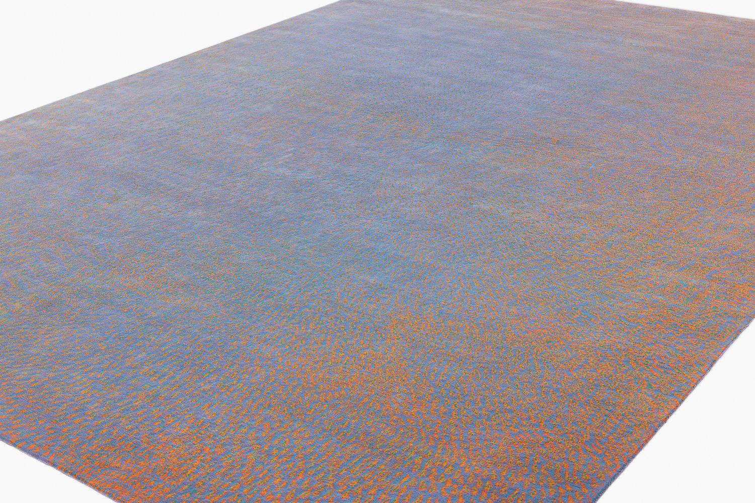 Dreampost is an incredible contemporary luxury carpet design by Joseph Carini. Drawing inspiration from stained glass, five colors melt together to create an aura of warmth. Shown here in 10 x 14 size with light blue, purple, orange, green and