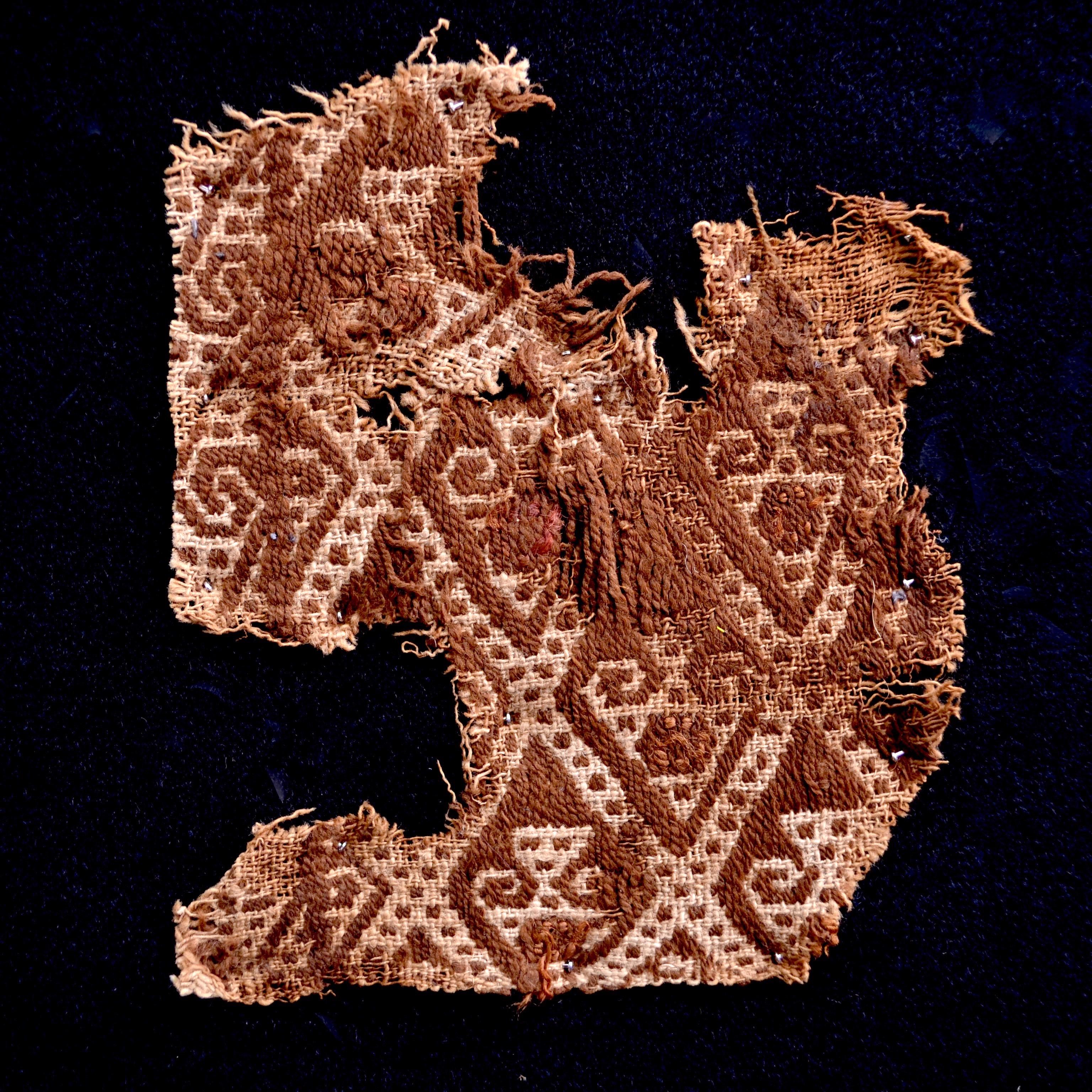 Earth tones pre-Columbian textile fragment with abstract embroidered figures. This piece is framed in a black shadowbox.

It is a wonder to behold antiquities such as a pre-Columbian textiles, an authentic piece of art that has been preserved for