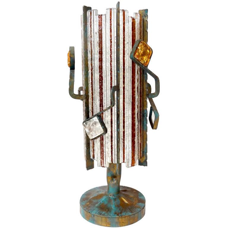 An abstract etched and patinated bronze lamp with clear and colored glass in the style of Poliarte.

Italian, Circa 1970's