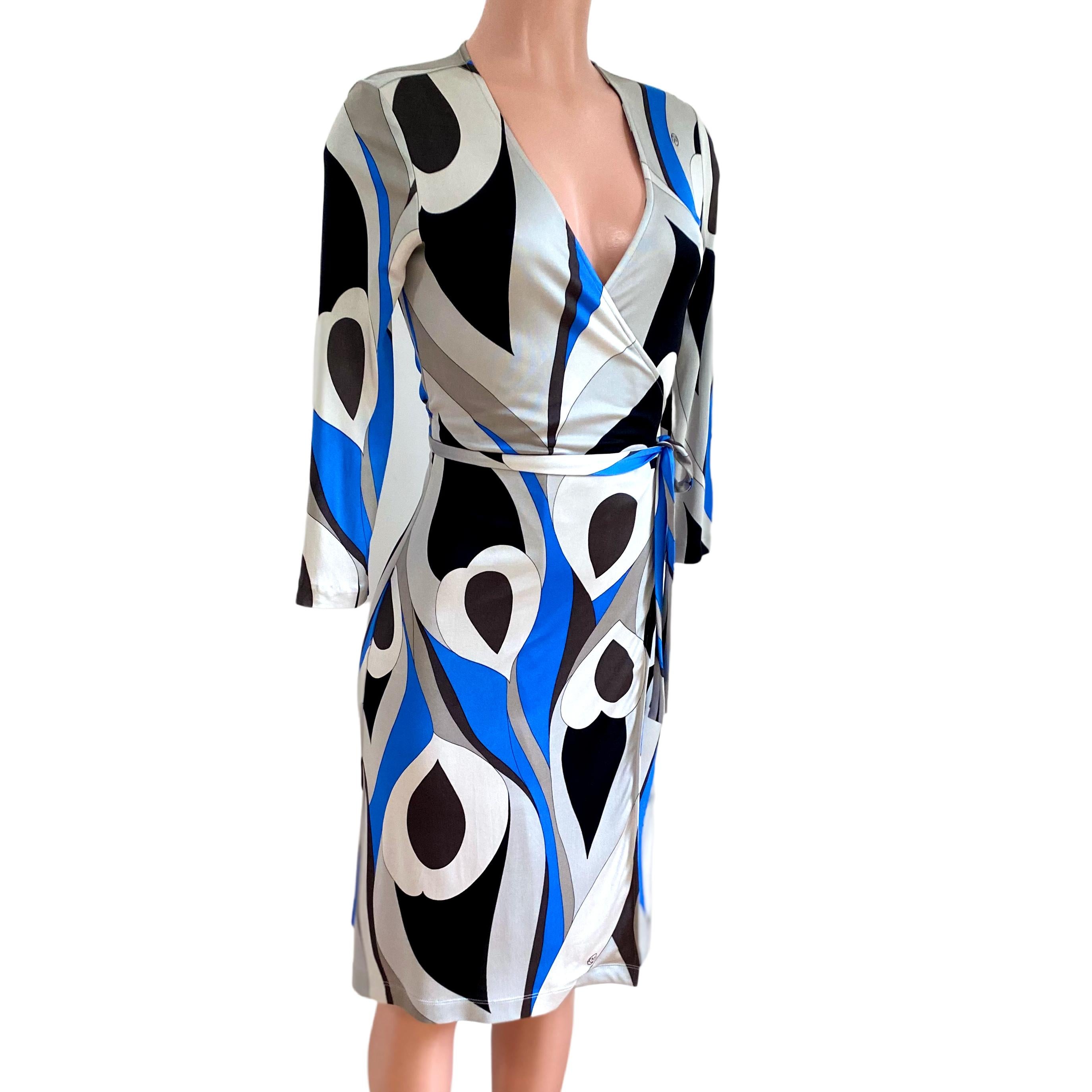 True wrap dress in abstract black, gray and blue feather print on buttery silk jersey.
Authentic FLORA KUNG silk dresses are made in premiere quality, long-filament silk yarn which gives a natural simmering glow and a buttery, luxurious feel. 
US 4