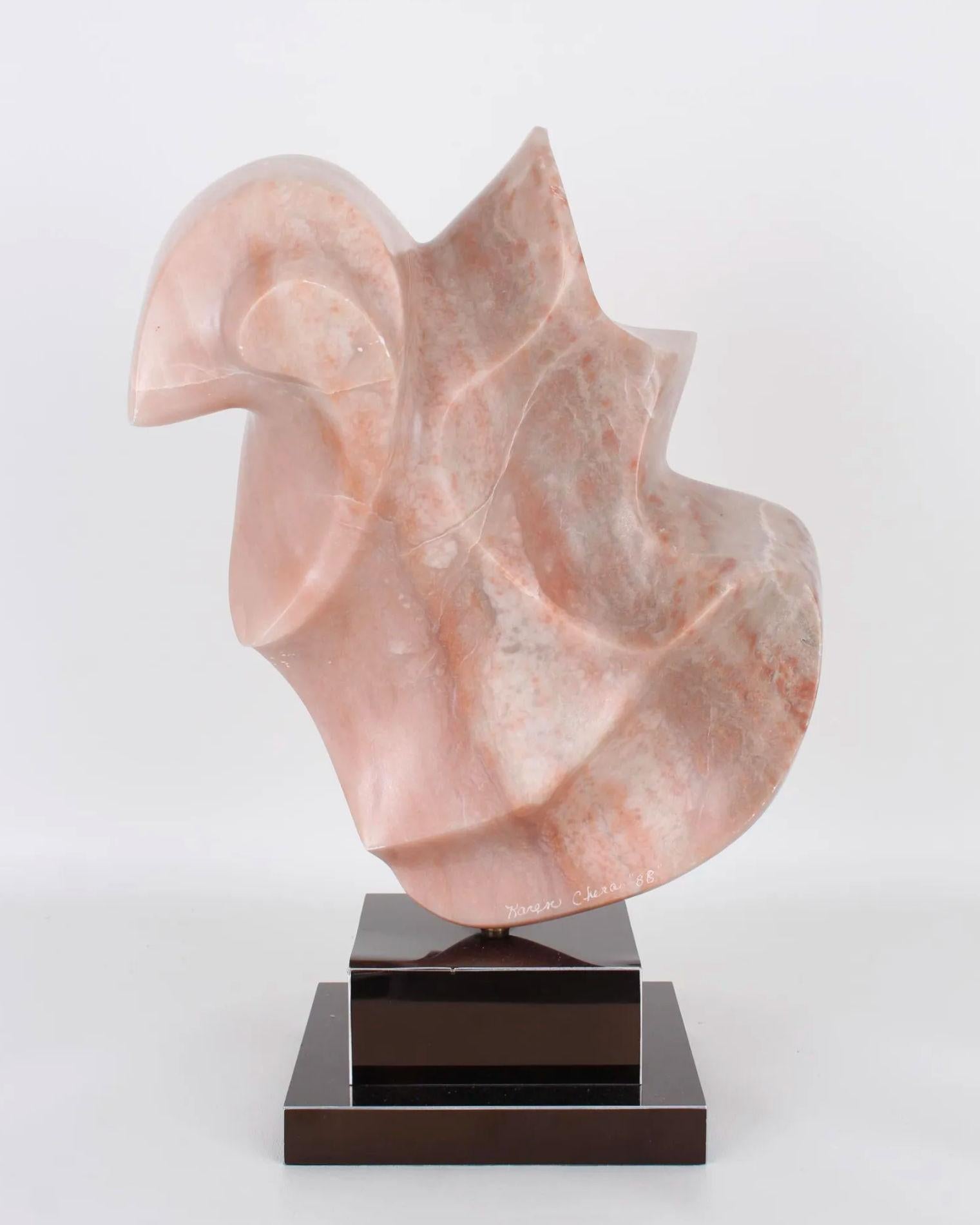 Abstract Pink Alabaster Sculpture by Karen Chera, signed and dated '88. on its original metal base.