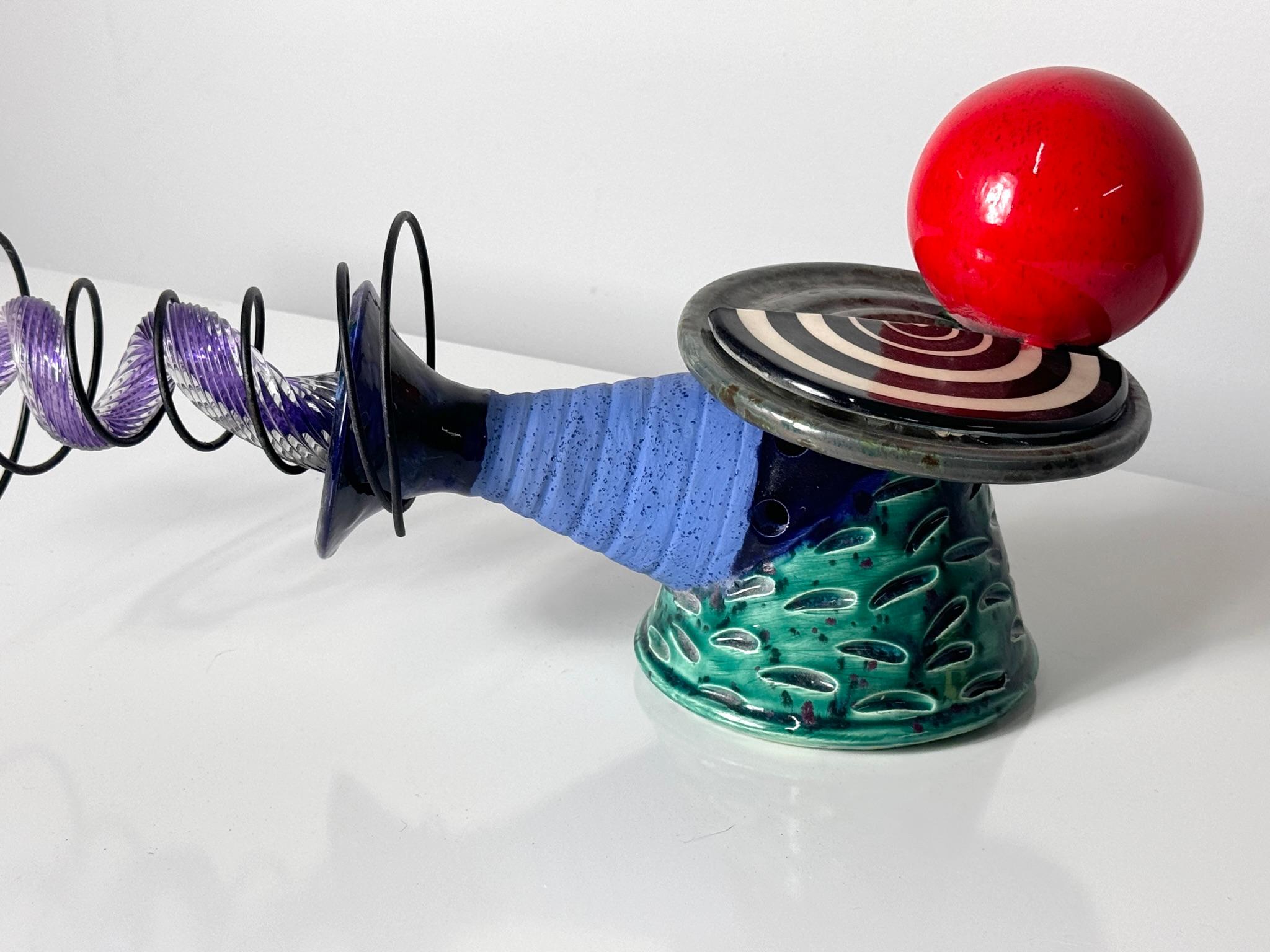 Large abstract mixed media ceramic sculpture by Kaiser Suidan Studio 2001

Post Modern Memphis style design of mixed elements and colorful glazes with a rare incorporation of sculpted glass within coiled wire
Signed and dated

Suidan's sculptures