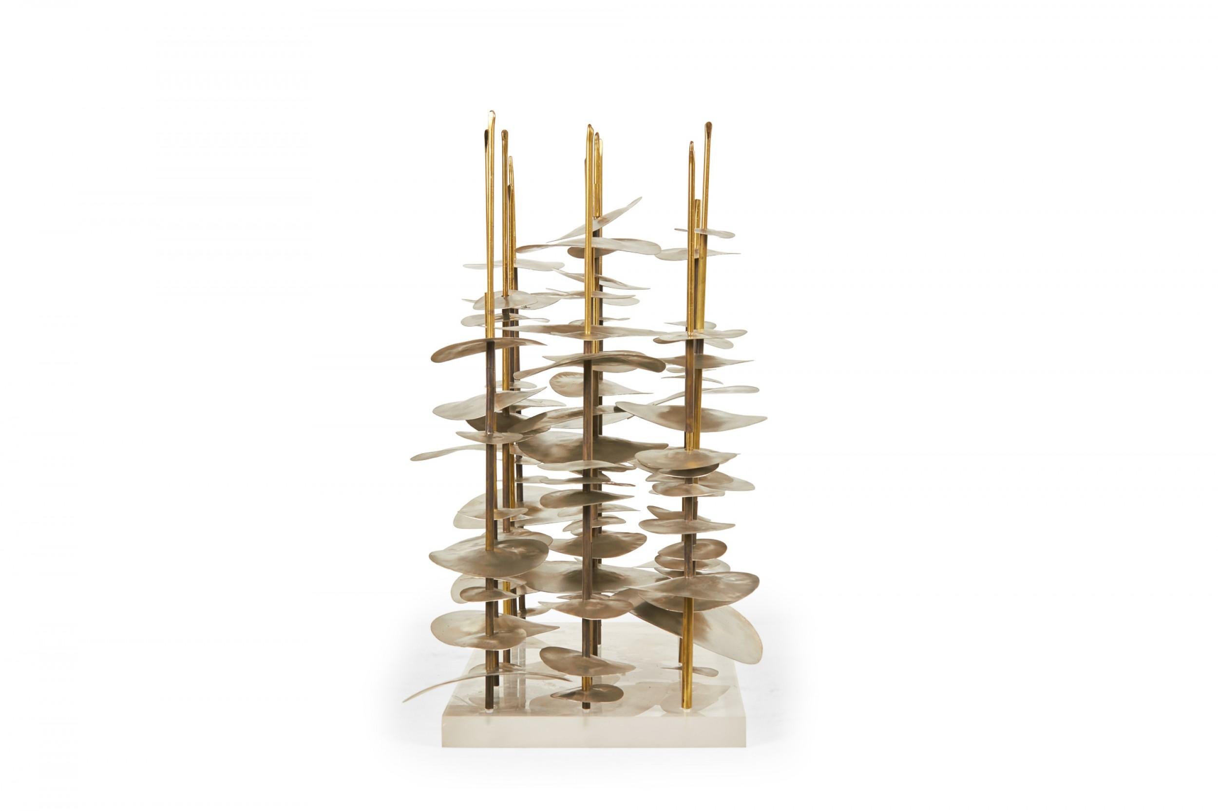 Contemporary abstract sculpture comprised of a various sizes of oval nickel pieces stacked on brass rods mounted on a rectangular lucite base titled, 