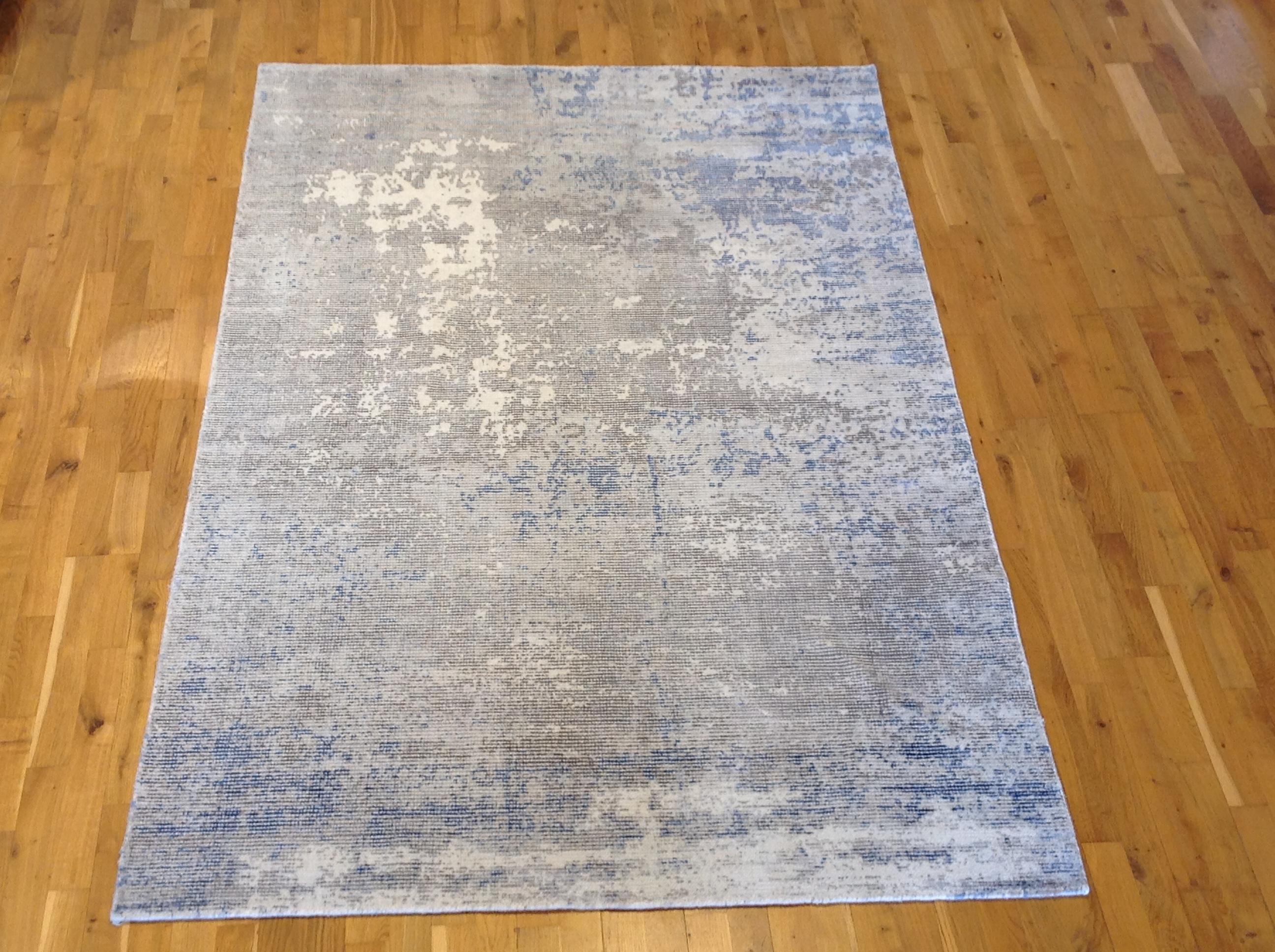 Stunning grays and blues abstract design area rug.
