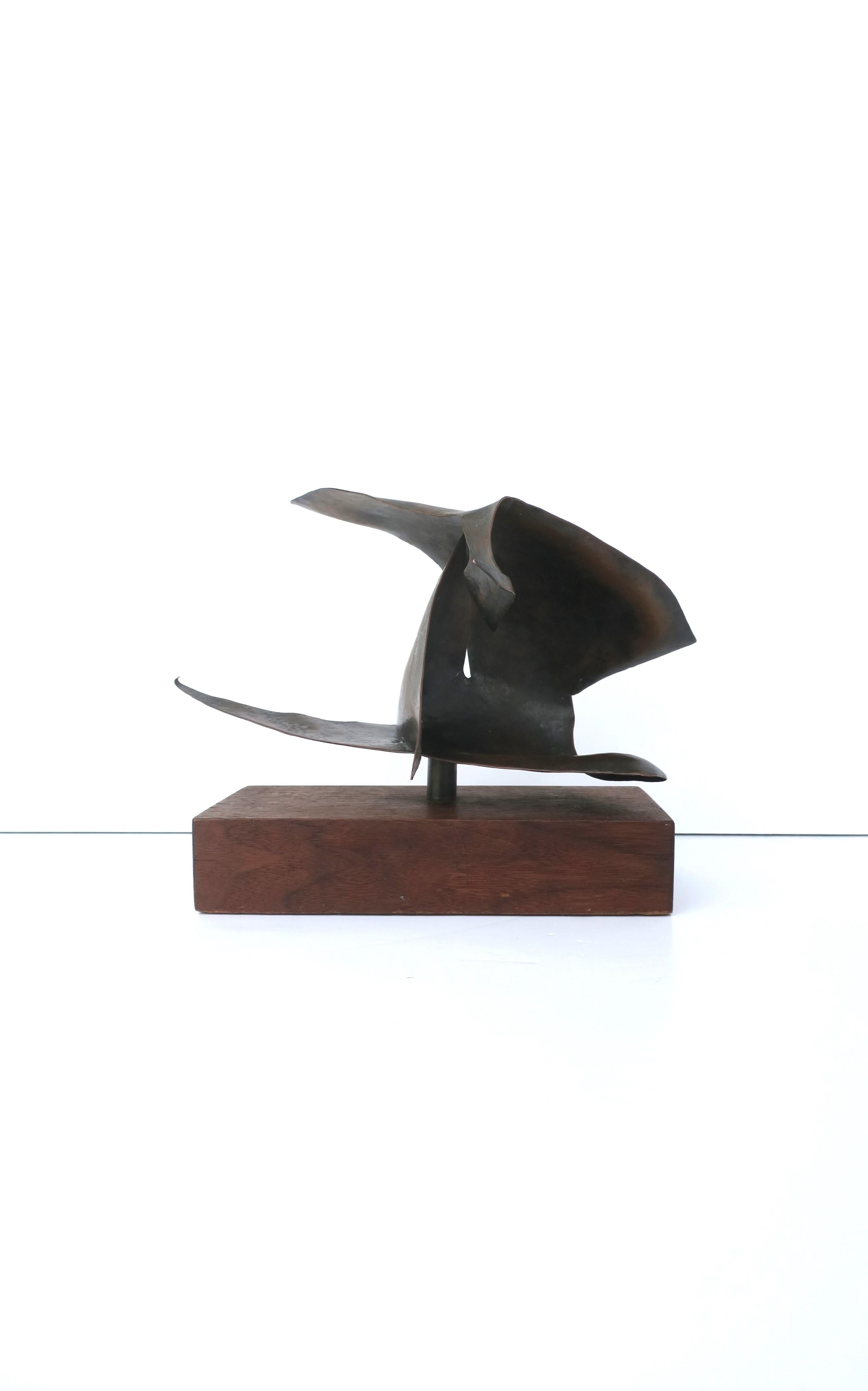 A signed copper abstract sculpture on wood base, circa 1960s. Sculpture is copper, with a beautiful rich dark brown patina, adhered to rectangular wood base. Signature (illegible) on corner as shown in very last image. Beautiful as a standalone