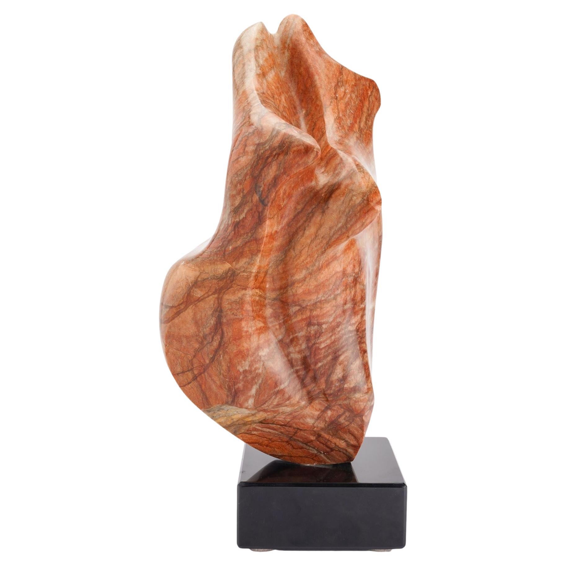 Abstract sculpture in rouge marble mounted on a Belgium black marble base