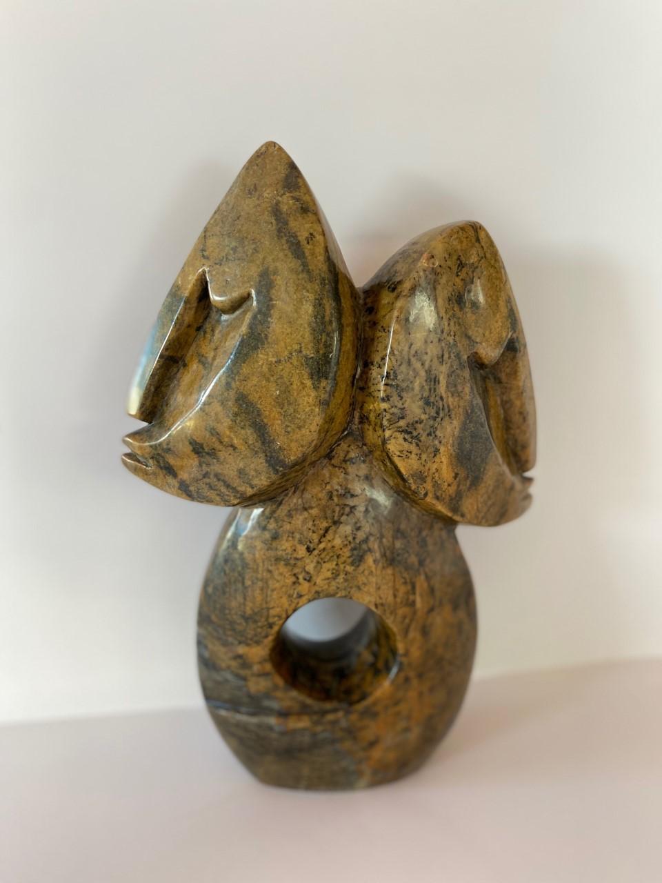 Incredible abstract sculpture by Tafadzwa Tandi made out of a solid piece of serpentine stone. A 3rd generation artist of Zimbabwe, Tafadzwa learned the language of stone by his father, pushing his craft and talent to be bolder and more daring. This