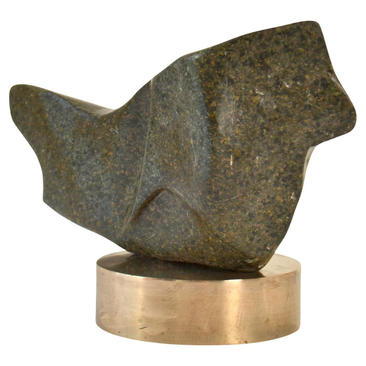 Hand-carved sculpture in moss green marble / granite on a polished round bronze plinth by the late Alice Ward. Her sculpture echoes a voyage of discovery in not just the visible natural world of rocks and landscape with her exploration of space and