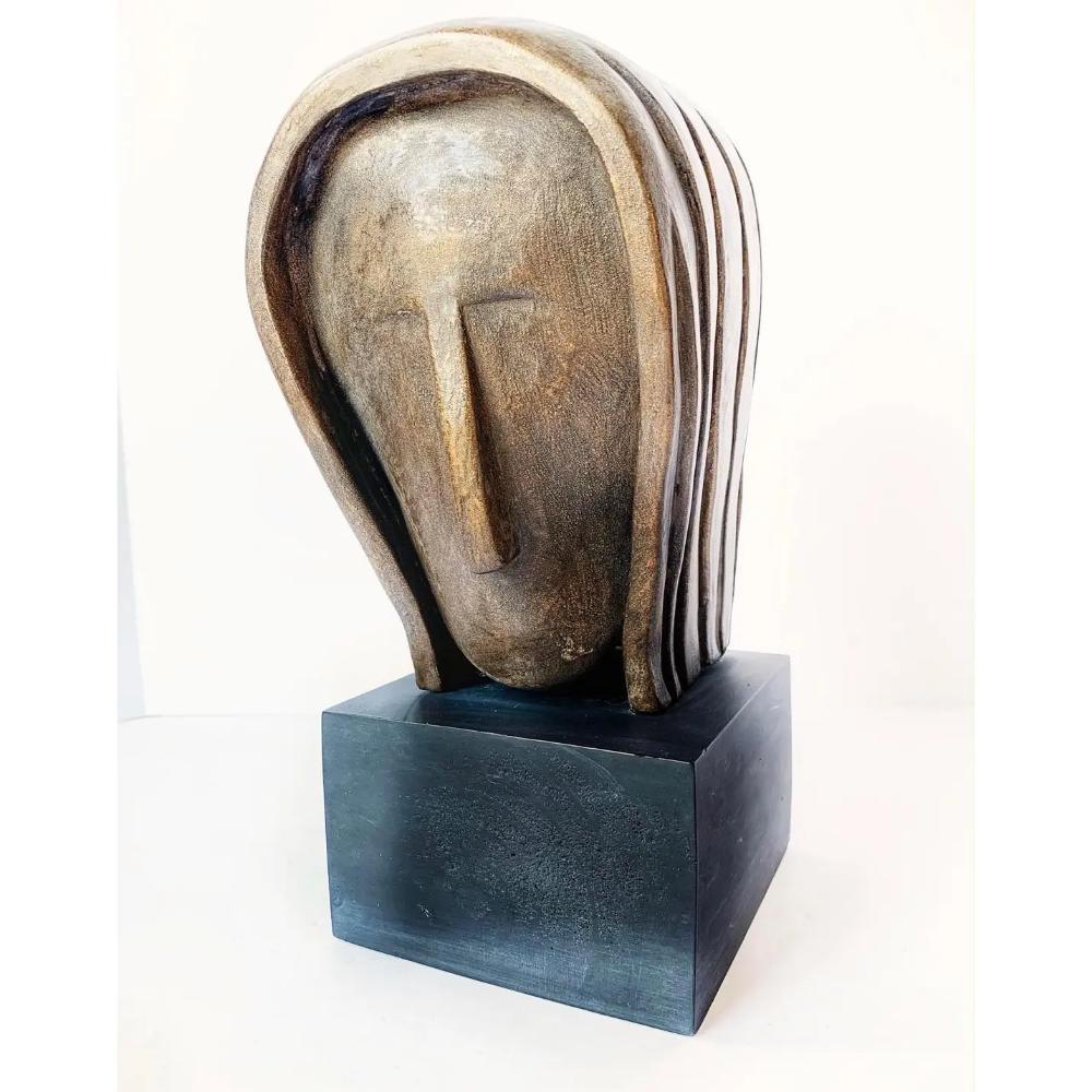 Sophisticated abstract sculpture by the artist J. Dersh. A woman’s head finished in shades of Bronze and gold tones.