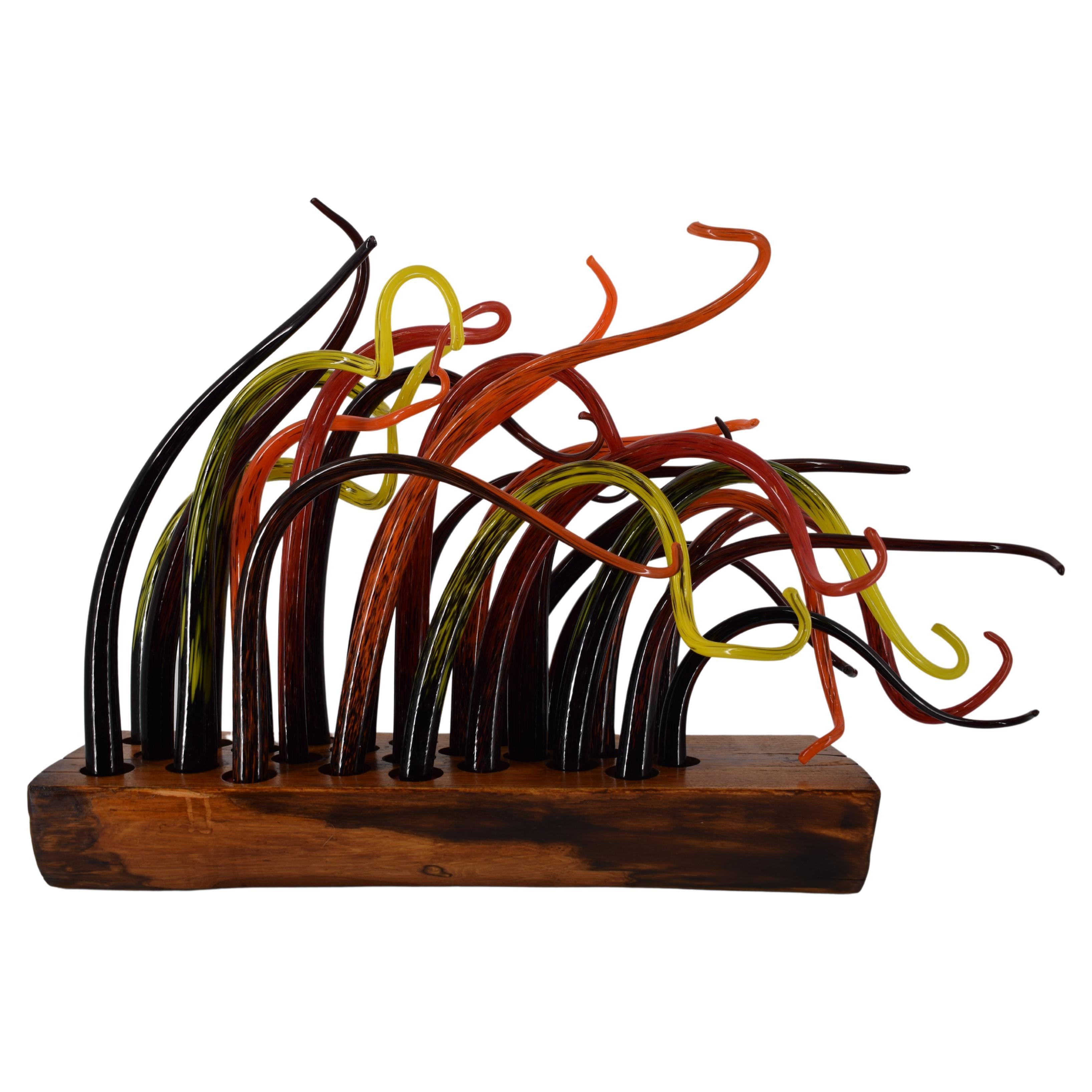 Murano artistic glass monolith. The Murano artistic glass sculpture is a creative and natural expression of the artist Eros Raffael, made of blown Murano glass and wood by Eros Raffael, in this sculpture are enclosed in perfect irregular shapes: the