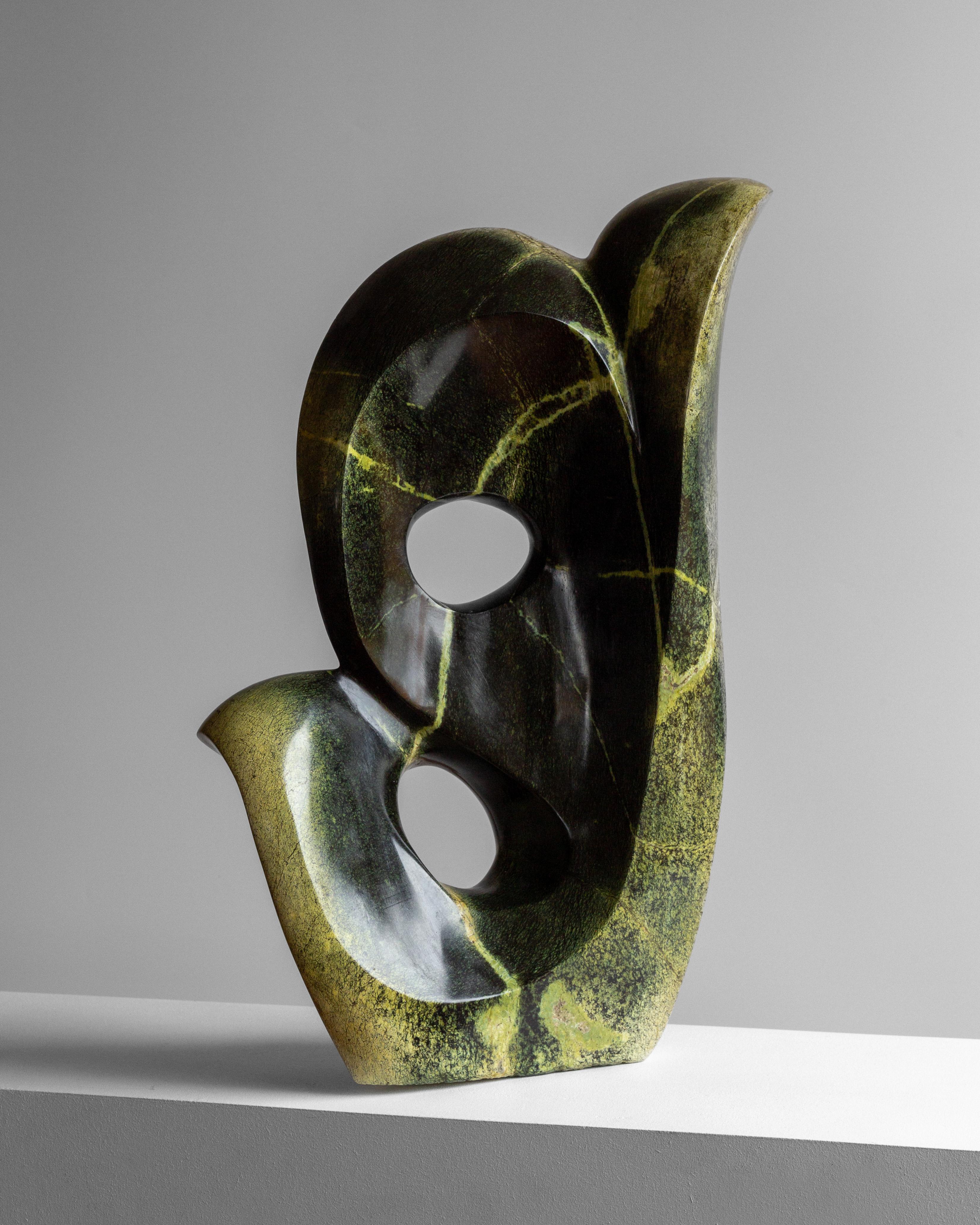 A striking abstract stone sculpture from the late 1990s to early 2000s, created by Zimbabwean artist Peter Chidzonga, a prominent figure in the Shona Art Sculpture movement.

This large, heavy, and beautifully formed abstract composition is