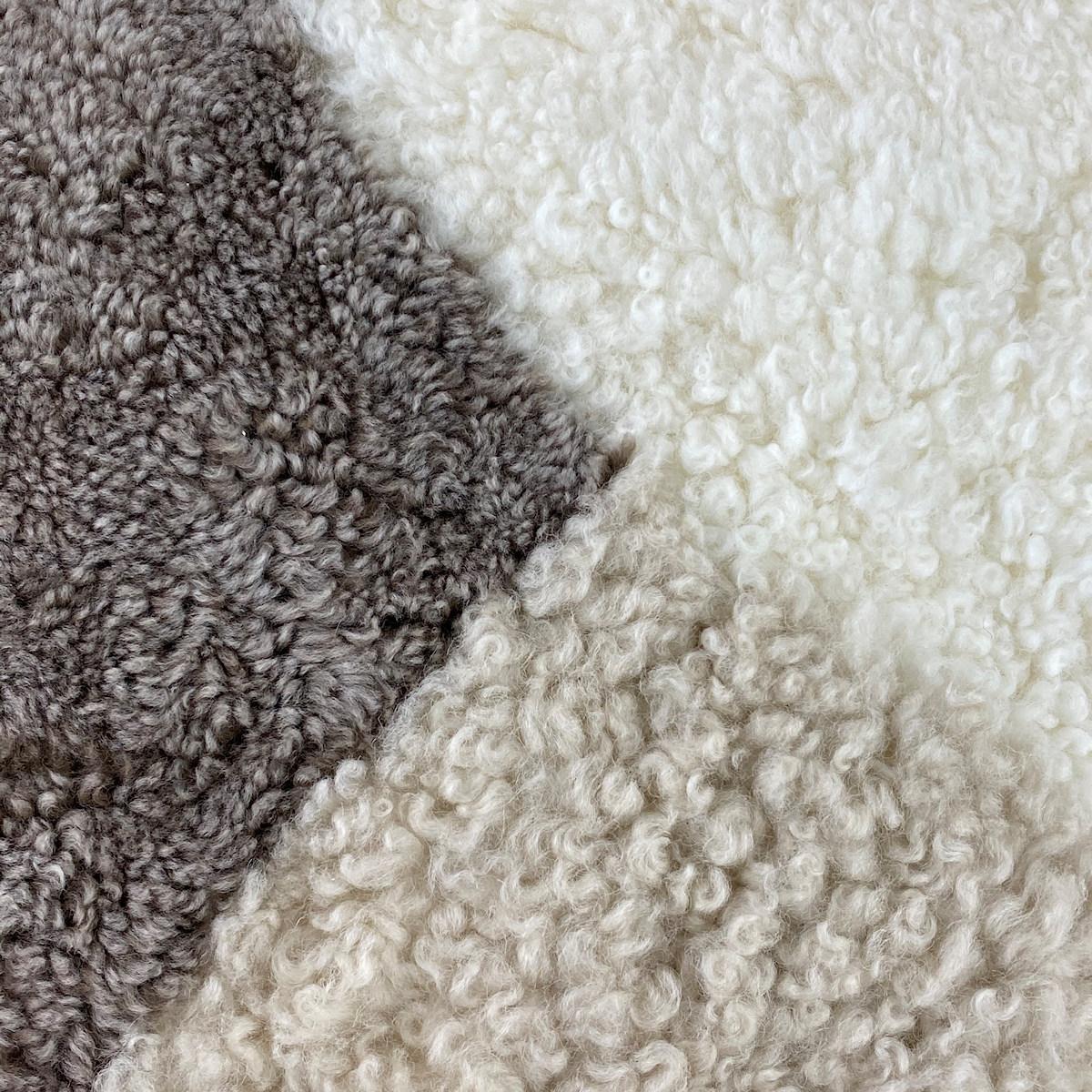 Introduce comfort and an expression of sustainable living found in this stone shearling sheepskin abstract pillow. The boucle style wool pile features a short curly wool that will bring a room to life, injecting charming tactile elements translating