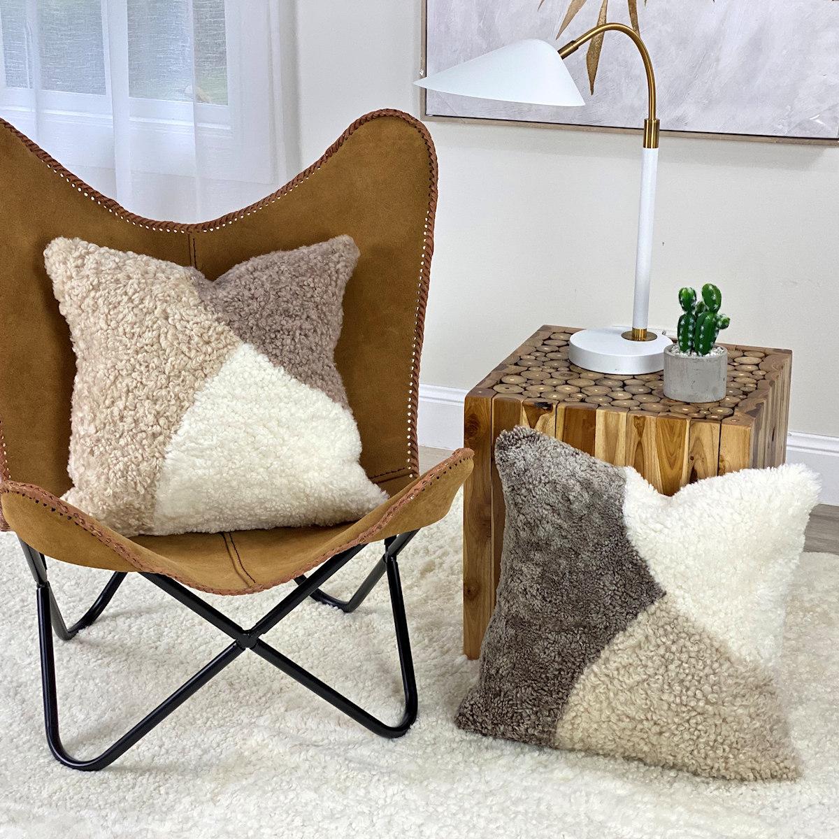 Introduce charming tactile elements found in this natural pebbles, abstract shearling pillow. The boucle pillow features short curly wool that will bring a room to life, translating contemporary design paralleled with comfort and an expression of