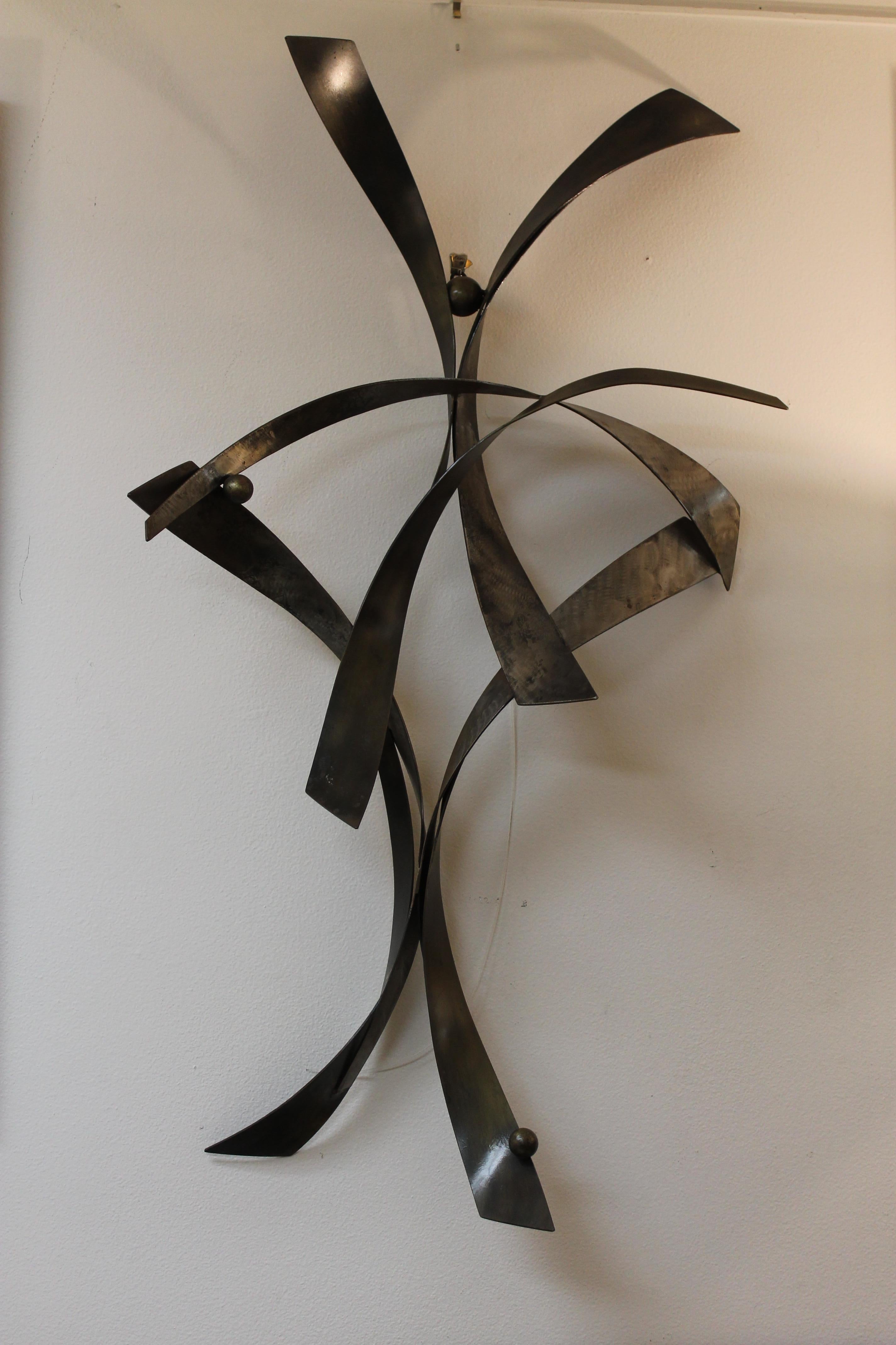 Brutalist steel wall sculpture with original patina. There are 2 steel rings which enable this sculpture to hang either vertical or horizontal. Sculpture measures 31