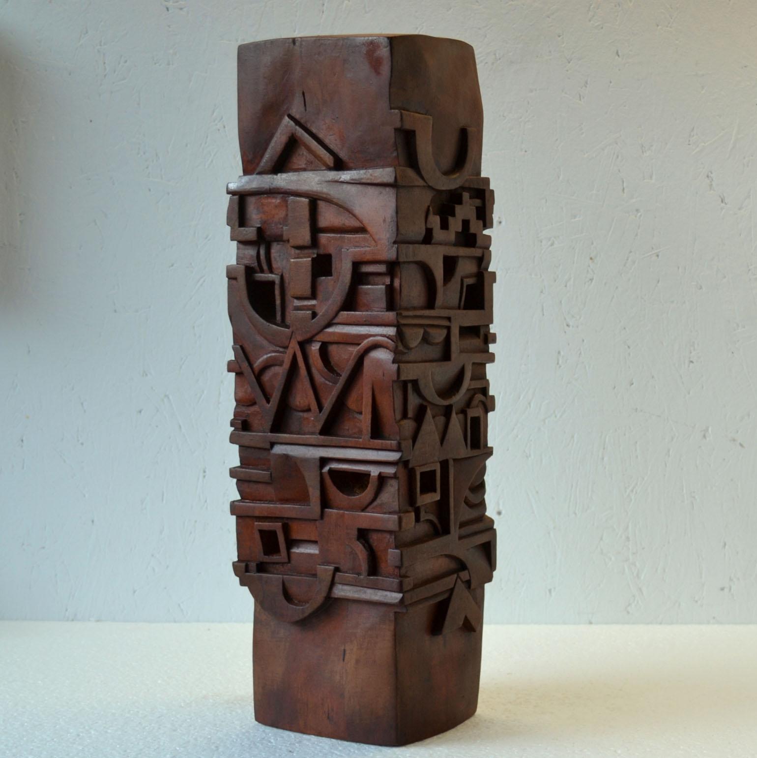Rectangular abstract totem sculpture carved with letters and symbols and stained in red-brown hard wood, by T. Sabri, France 1987.
The Totem is a tower that communicates through a visual language of symbols, pictures, objects, letters and words.