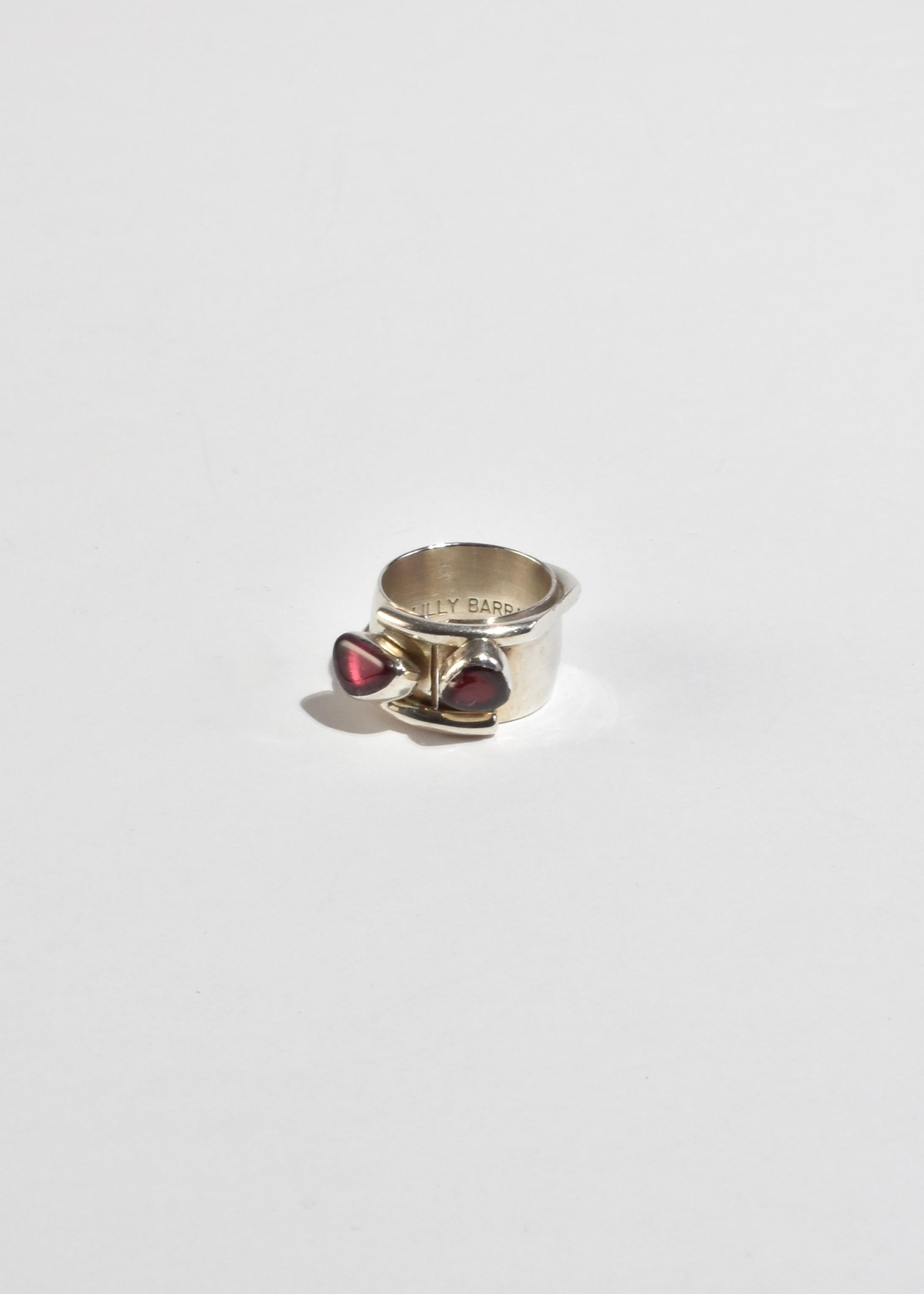 Rare, vintage sterling wide band ring with an abstract design and organic pink tourmaline and ruby stones. Stamped Lilly Barrack 925.

Material: Sterling silver, tourmaline, ruby.