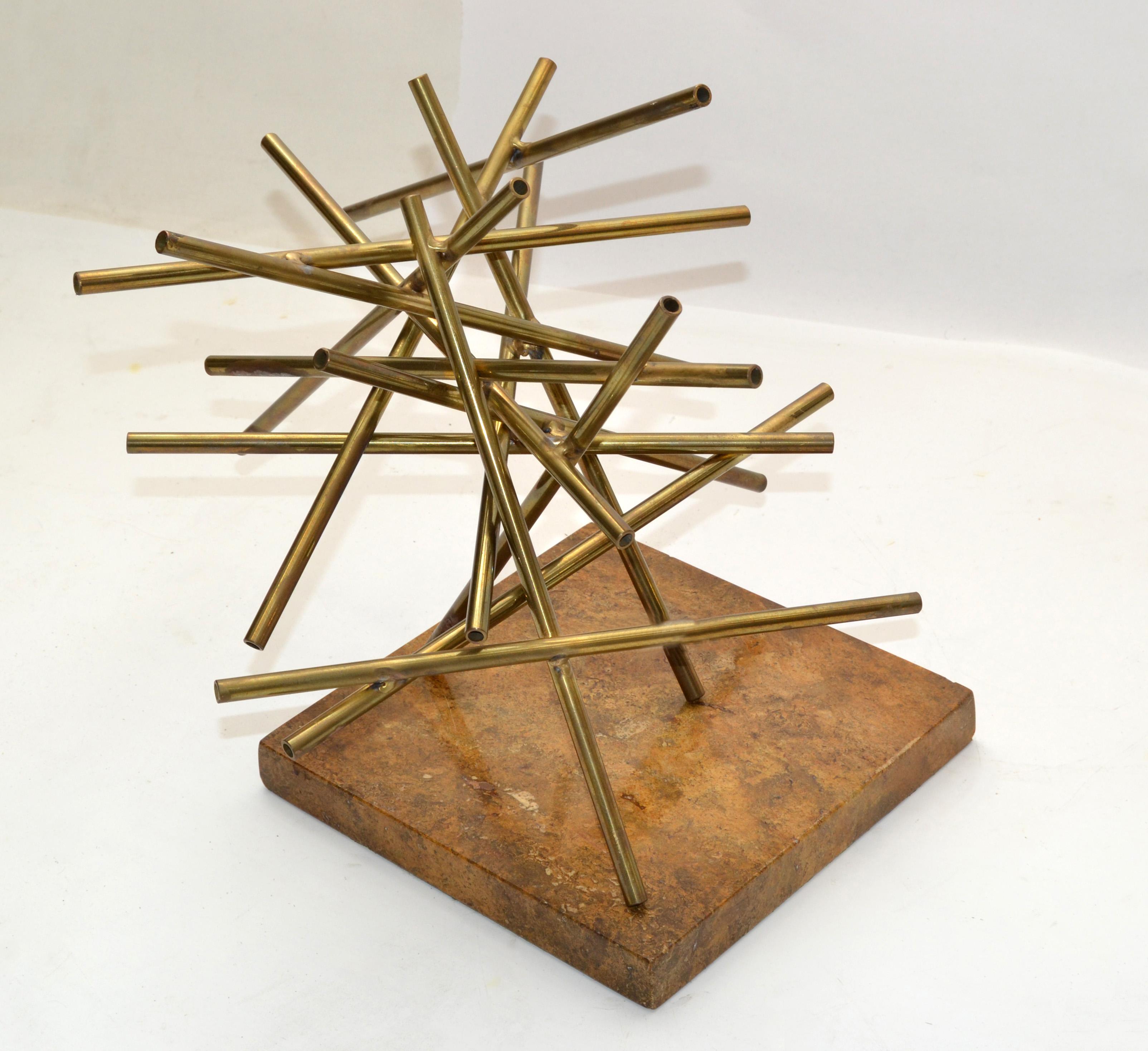 Mid-Century Modern handmade abstract geometric table sculpture made out of tubular Brass pieces welded together and placed on a square brown Marble Base.
The marble base is covered with a green felt.
Stunner done and interesting look from any