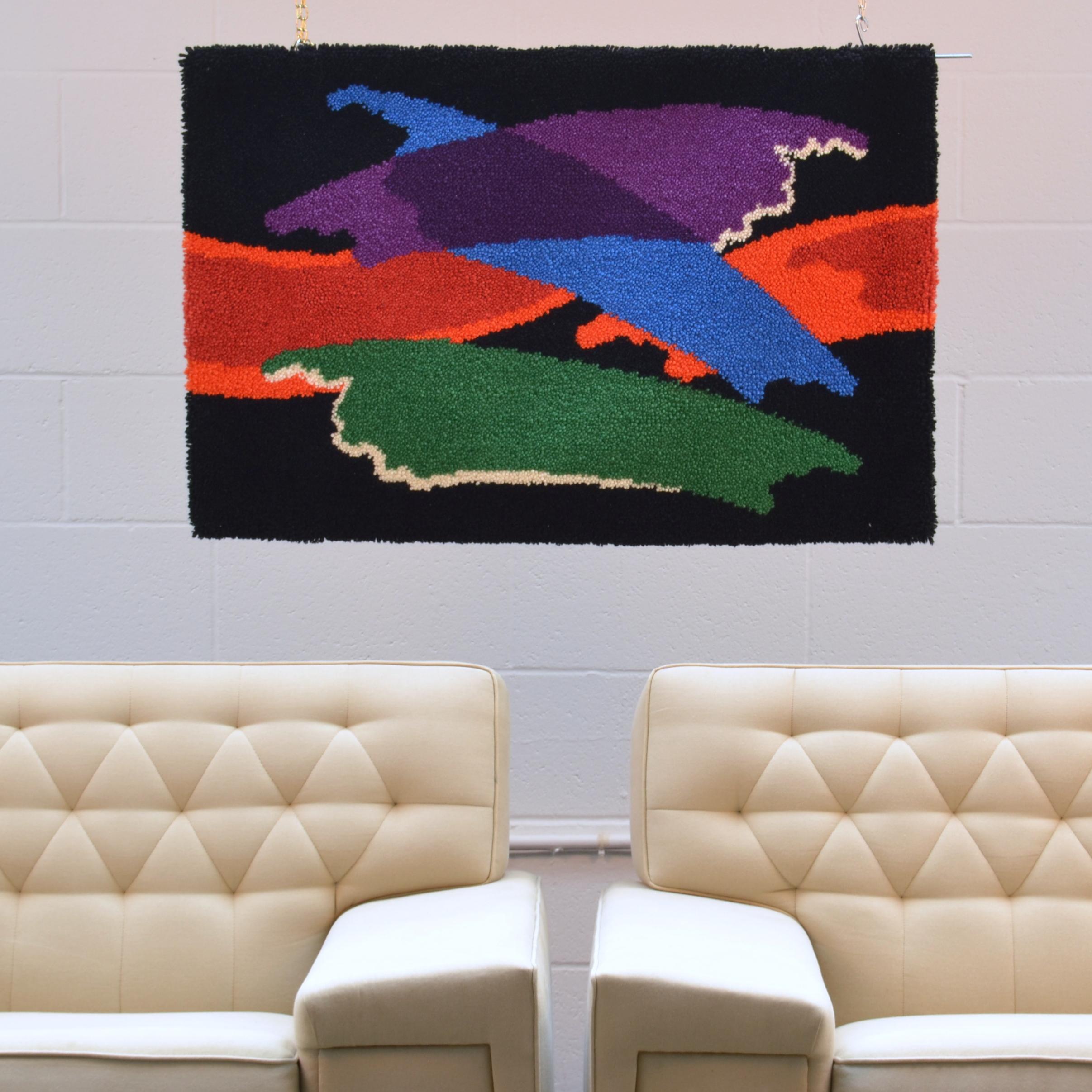 Colorful hand knotted wool hanging is probably a translation of the work of an artist. This was a time when modern artists work began to work with weavers who would translate their paintings into a tufted canvas. The resurgence of tapestries in the