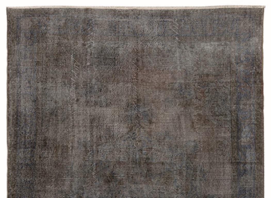 A vintage Turkish area rug over-dyed in gray color.
Finely hand knotted, low wool pile on cotton foundation. Deep washed.
Sturdy and can be used on a high traffic area, suitable for both residential and commercial interiors.