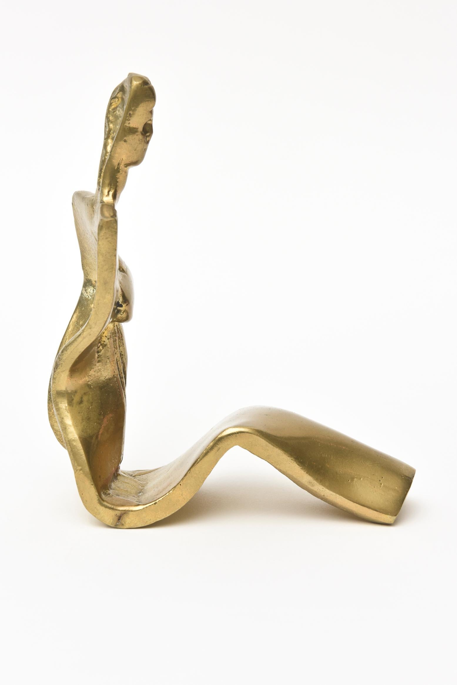 This lovely brass vintage limited edition brass abstract sculpture of a seated woman is signed but not legible and it is numbered 21 /100. It is great from all angles and makes a great desk or cocktail table accessory. It retains the original patina