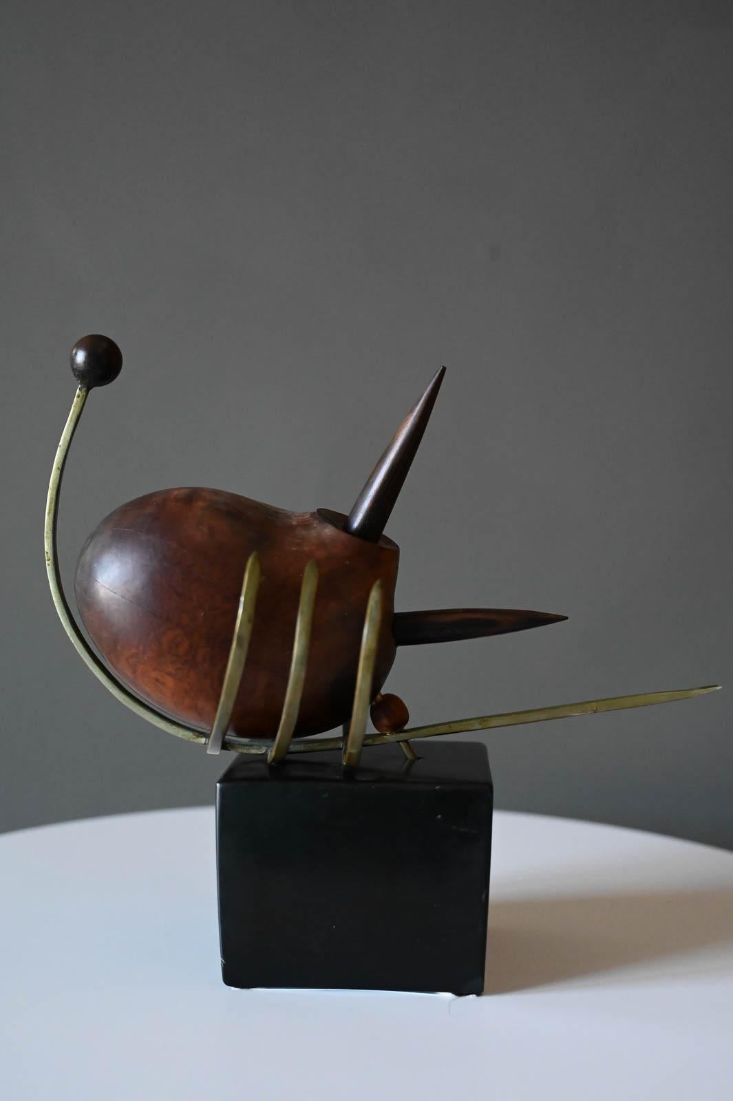 Abstract wood and brass Scorpion sculpture, circa 1965. Abstract brutalist style scorpion on black base. Beautiful carved wood with solid brass spikes and legs. Some cracking of wood as shown, still lots of character for this really unique piece.