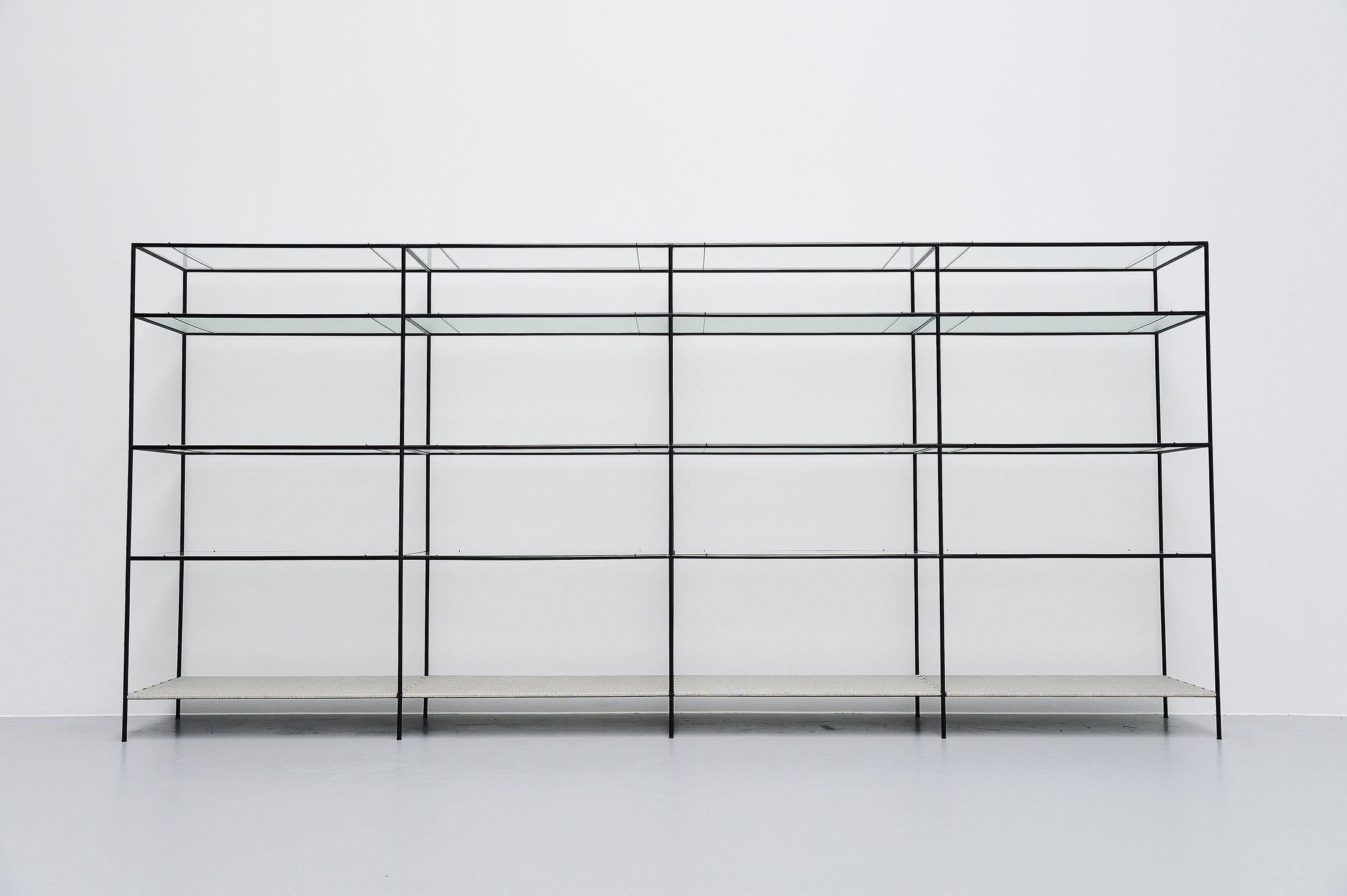 Very nice modern shaped 'Abstracta' shelving system designed by Poul Cadovius produced by Royal System, Denmark, 1960. This timeless system exists of black lacquered metal tubes with connectors, float glass shelves on very nice metal wire supports.