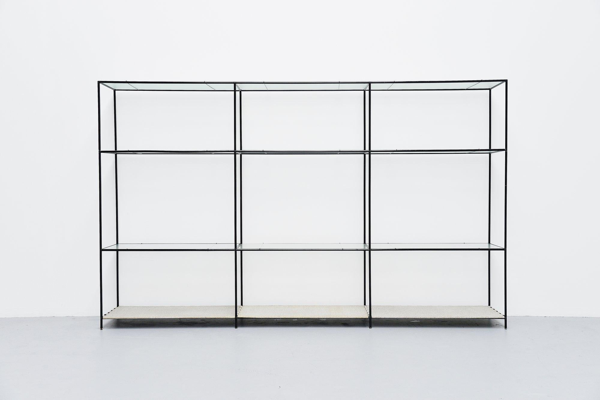 Very nice modern shaped 'Abstracta' shelving system designed by Poul Cadovius and manufactured by Royal System, Denmark 1960. This timeless system exists of black lacquered metal tubes with connectors, float glass and metal shelves on very nice
