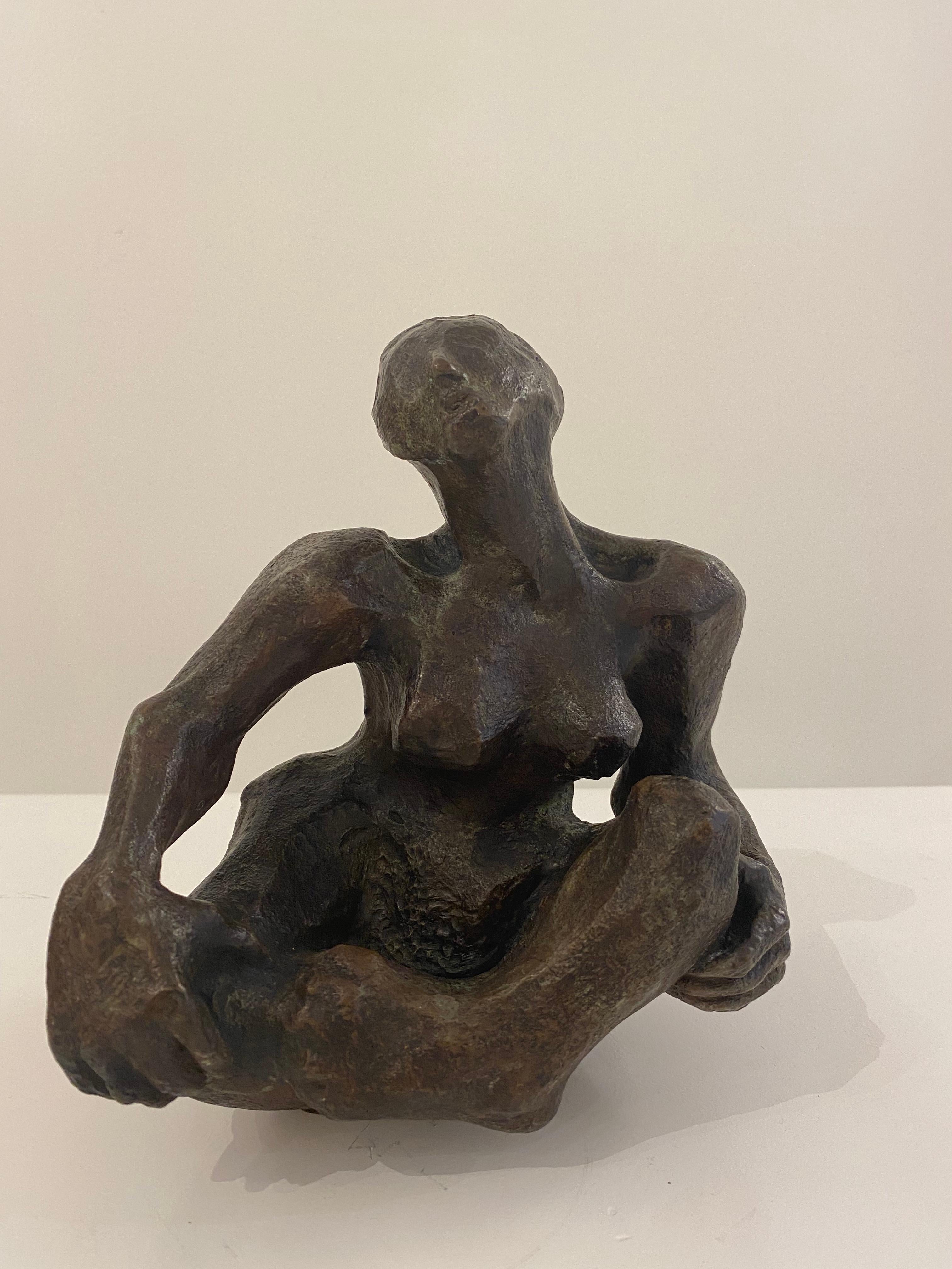 This is a patinated bronze abstract seated female figure. Distinctly patinated in a deep, rich brown, this sculpture drawS much attention! This work depicts a woman in a seated fashion with her hands on her knees. She appears to be leaning on to her