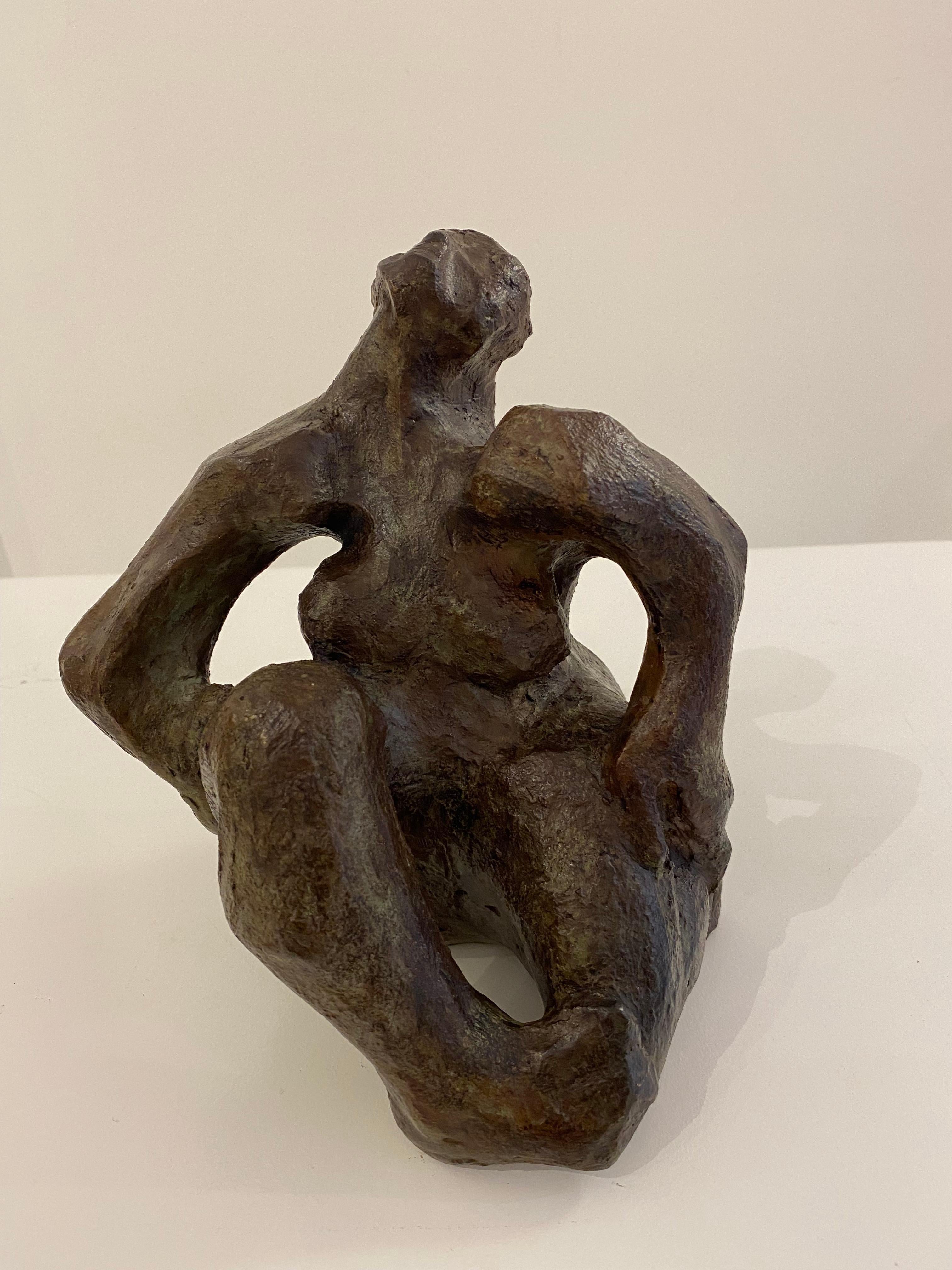 This is a patinated bronze of an abstracted seated female figure. Distinctly patinated in a deep, rich brown, this sculpture draws much attention! The sculptures depict a woman in a seated fashion with her hands by her side. She appears to be