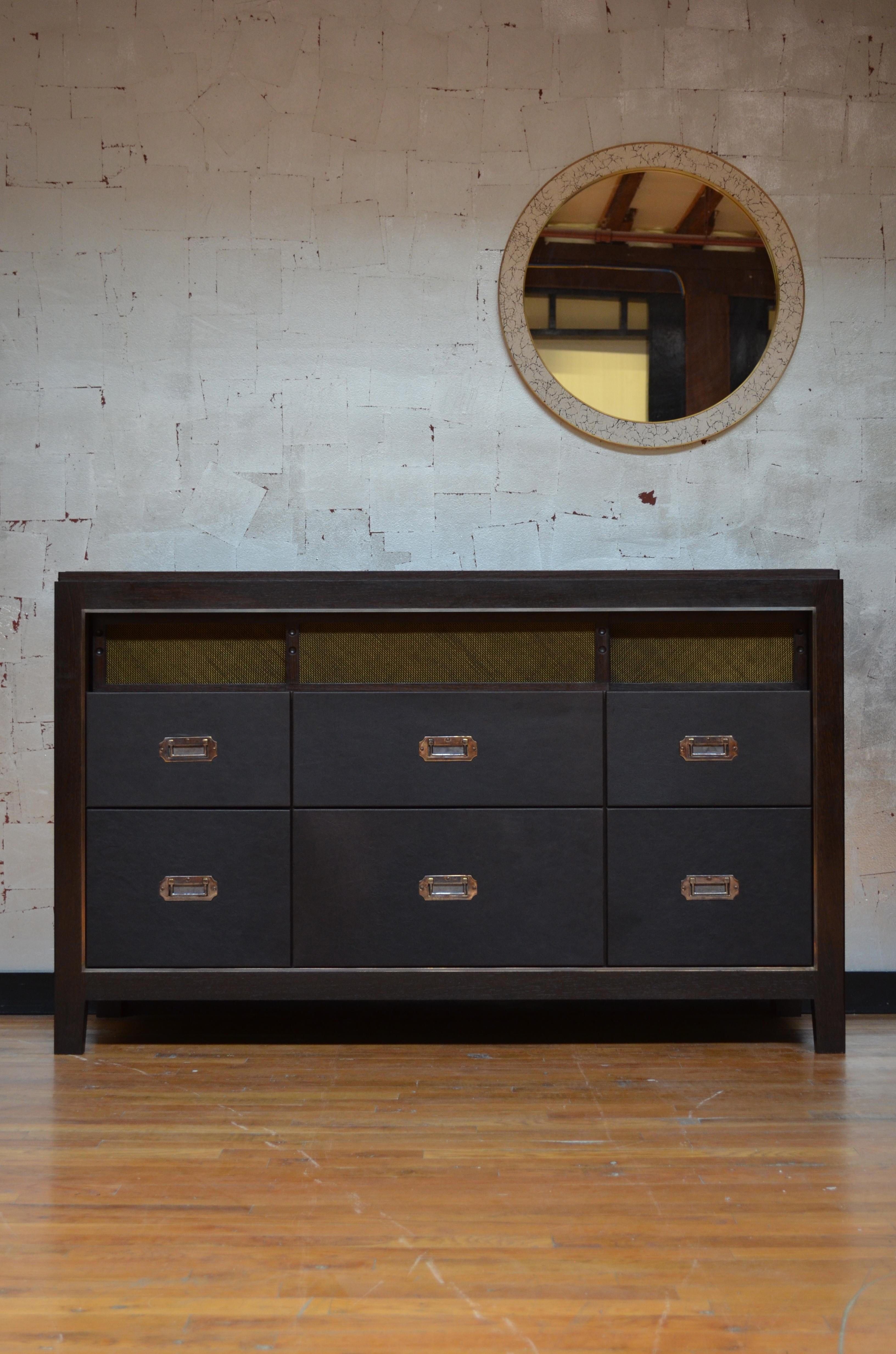 Crafted from rugged saddle leather, the Abuelo collection imitates the streamlined lines of a mid-century piece, while the luxuriousness and richness of its materials create a look all it’s own. Solid walnut-construction houses the brass framing of