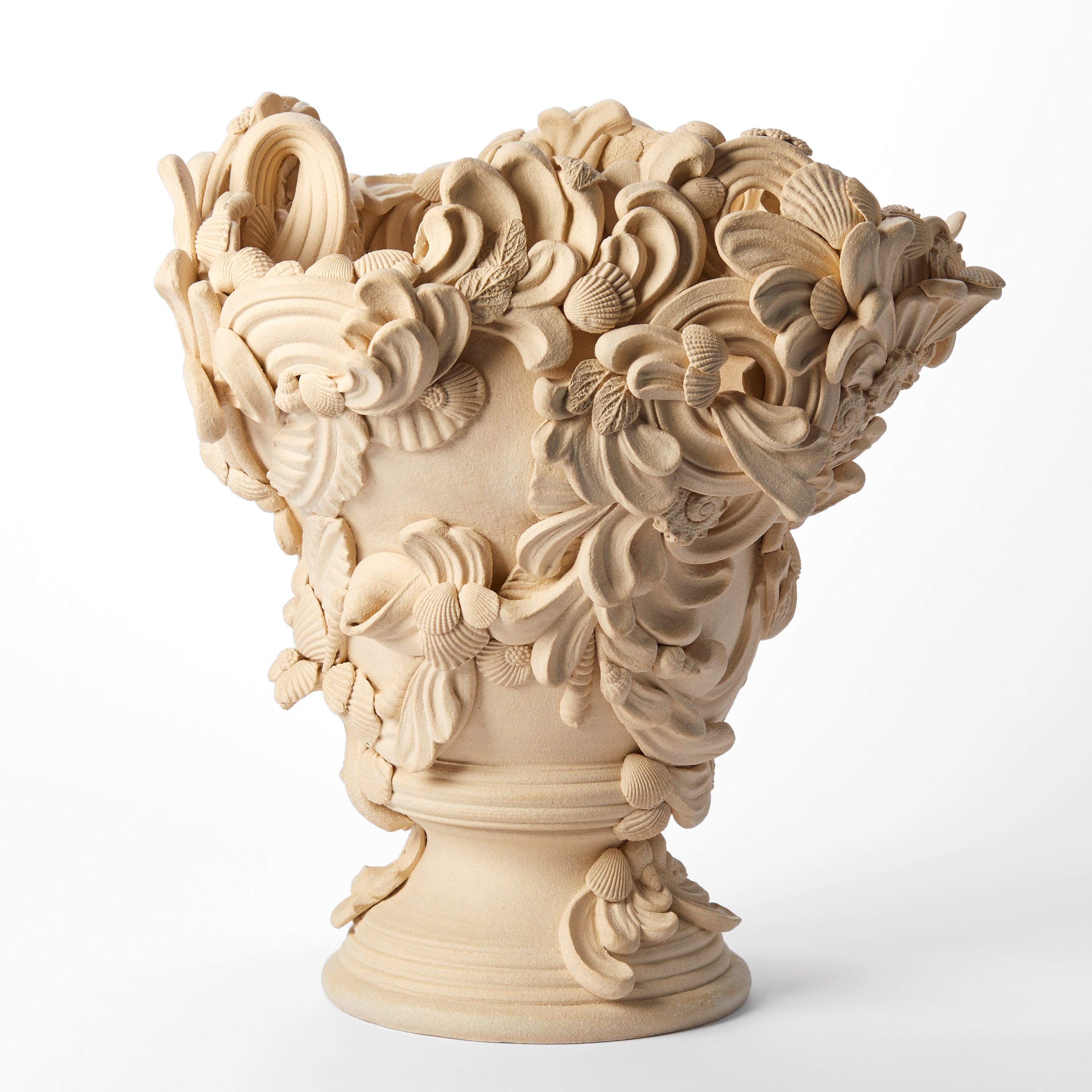 'Überfluss II'  ist eine einzigartige Keramikskulptur der britischen Künstlerin Jo Taylor.

Taylor lässt sich von hochdekorativen architektonischen Elementen wie verzierten Stuckdecken, Schmiedeeisen und behauenem Stein inspirieren. Da sie in der