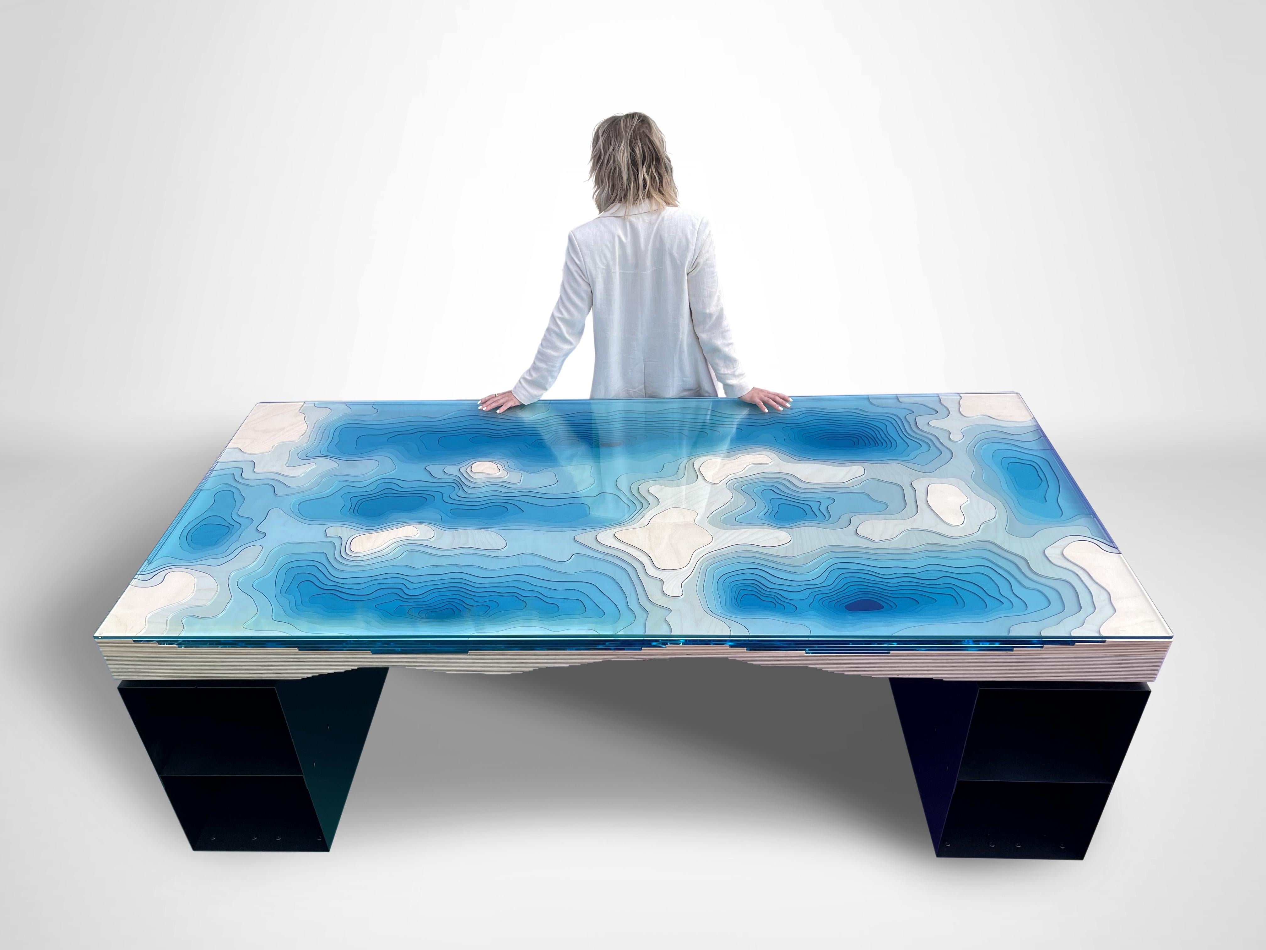 A modern piece of statement furniture from British designer Christopher Duffy. 

The Abyss Desk expands Duffy London's explorations of depth with a mesmerizing depiction of the Earth’s seabed, played out in vivid turquoise colours and grounded on