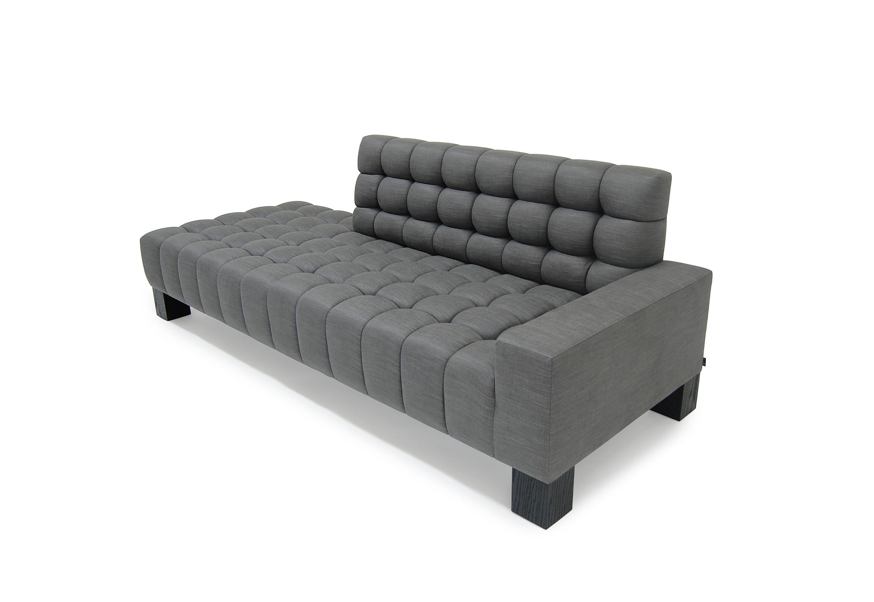 Asymmetrical contours of the Mini Abyss Sofa allow your eyes to roam to and from each of its unique ends. The horizon of the sofa is reminiscent of a casual lounge which melds into a cavernous nook where you can sit back and relax. The upholstered