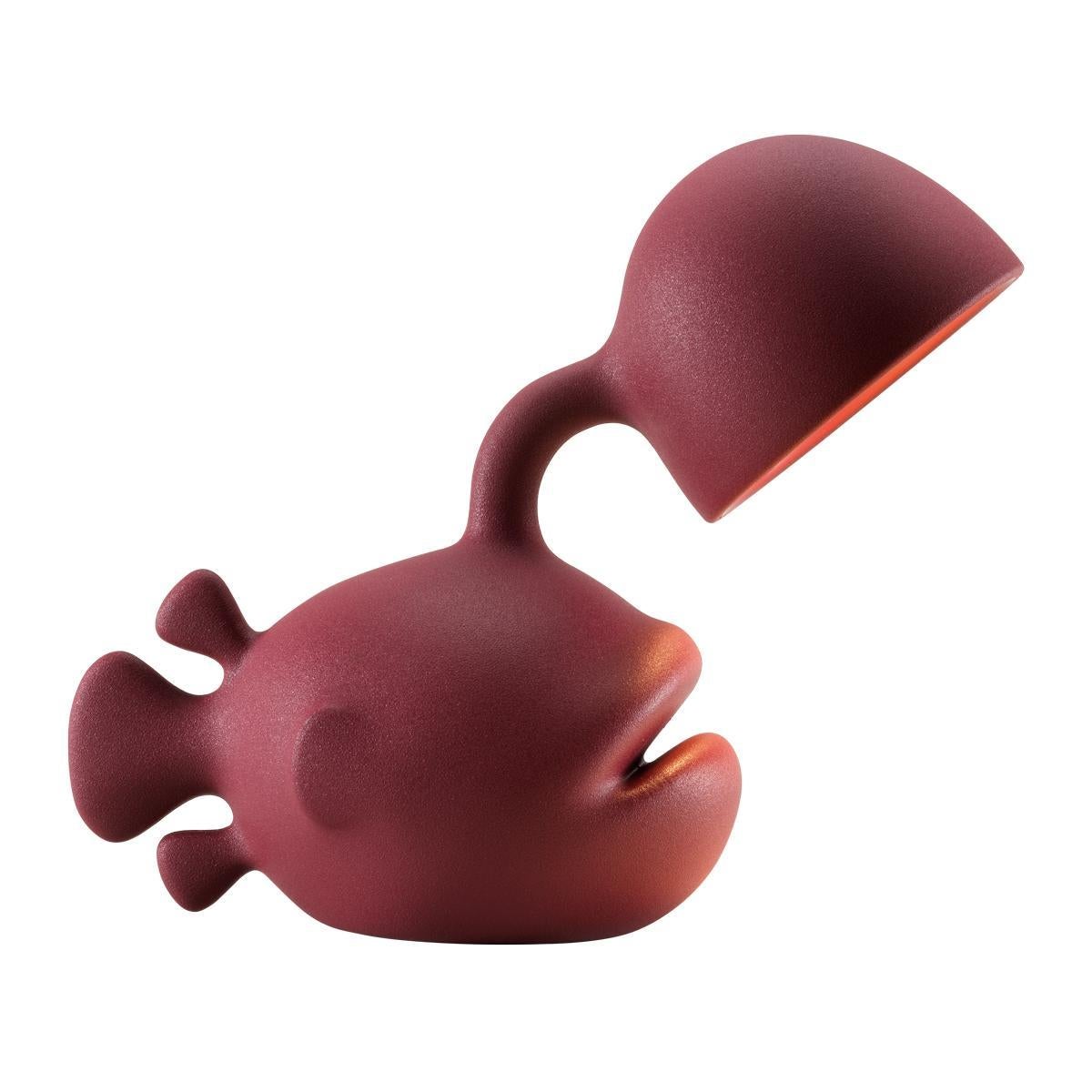 Designed by Dai Sugasawa, Abyss is a bold fish-shaped table lamp in recyclable polyethylene. Inspired by the anglerfish swimming in the deep seas with its luminous built-in rod, Abyss will dock directly to your house bringing light on your dining or
