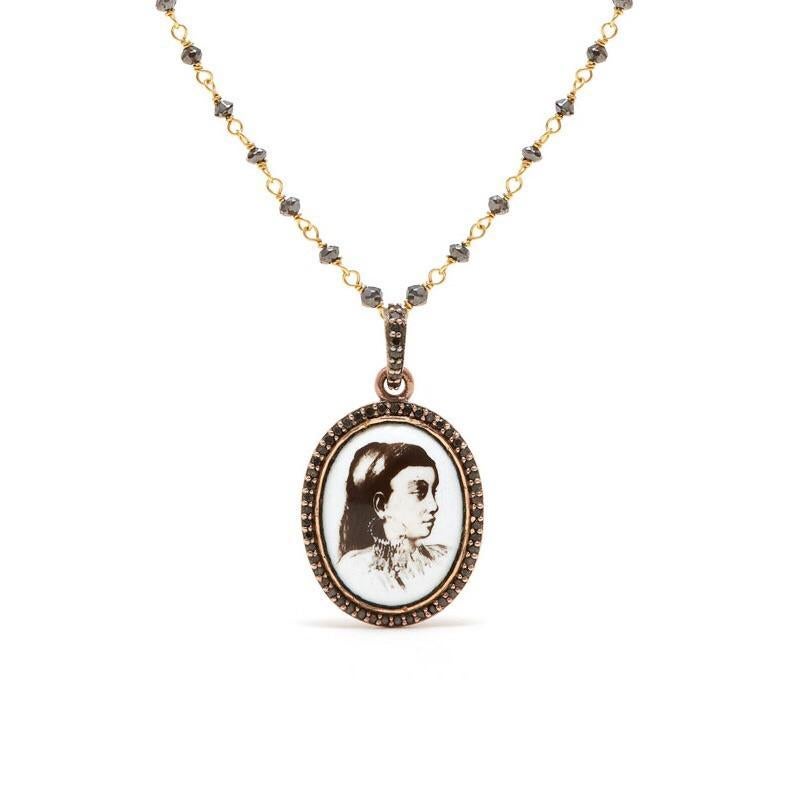 A truly one of a kind cameo pendant featuring a vintage image of an Abyssinian woman on a background of white enamel set with black diamonds in 18 karat gold suspended on a black diamond chain.

- Chain features natural black diamonds approx. 2.65
